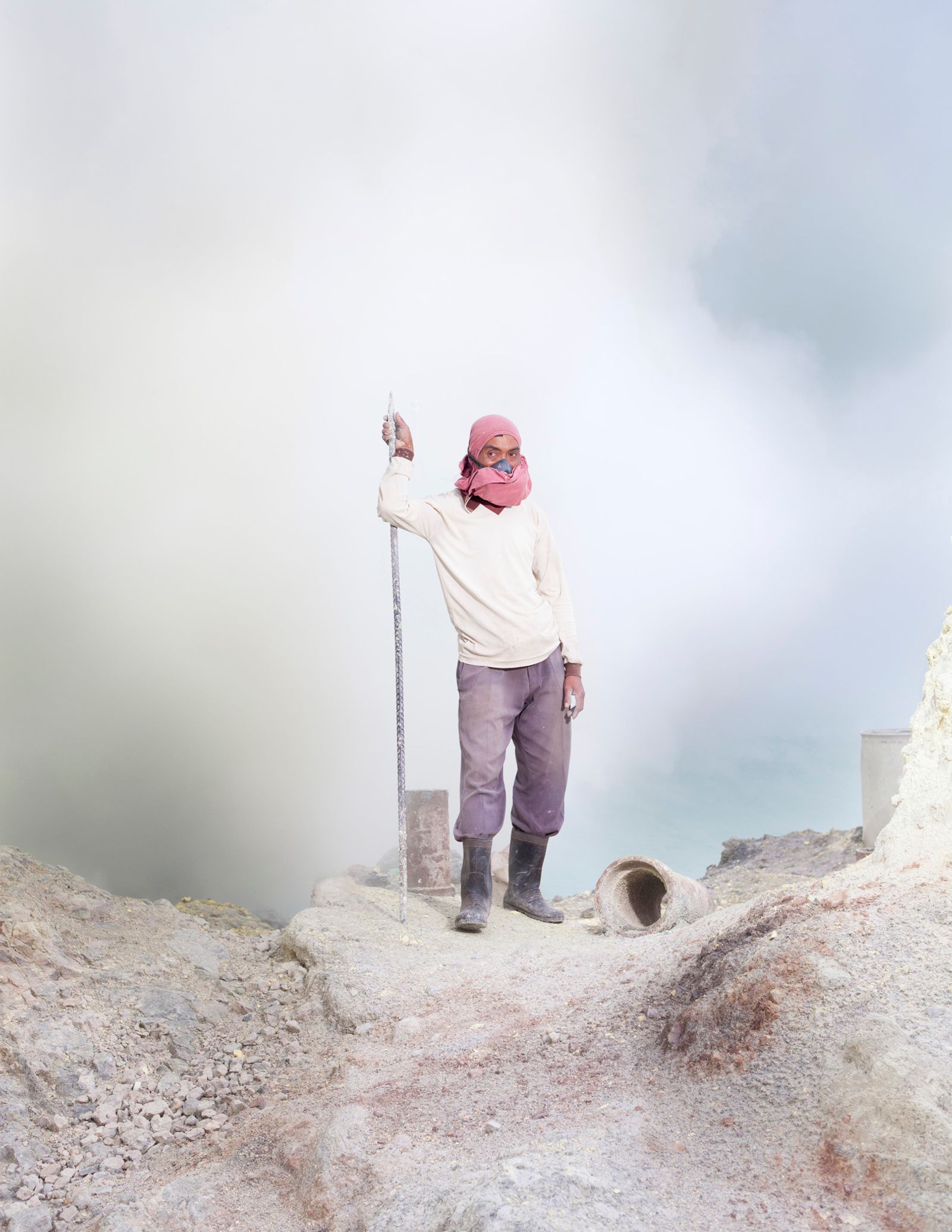© Hahn Hartung - A sulfur miner in the crater of the Ijen volcano.