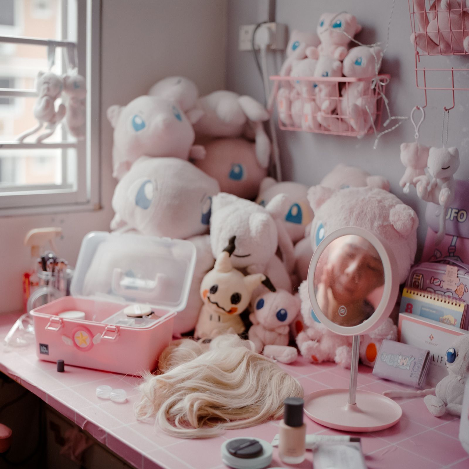 © Alvin Ng - Evelyn's stuffed toy collection of her favourite Pokemon Mew tucked away at the corner of her desk.