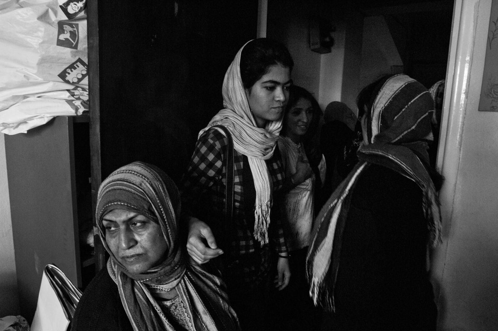 © Stephen Boyle - Afghan women queue for free clothing organised by a charity in central Athens. October 2012