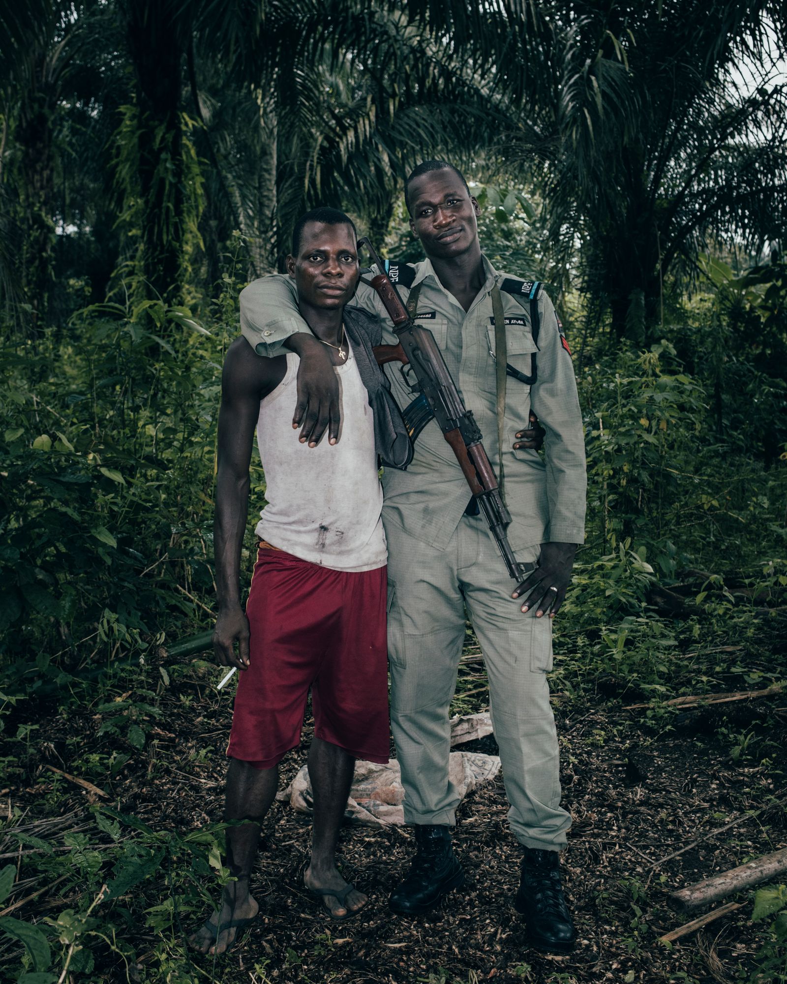 © Robin Hinsch - Reuben Ayuba, a local Police Officer in the Niger Delta, with a friend, Nigeria, 2019.