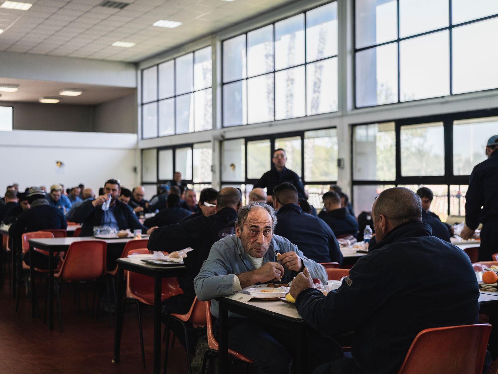 © Sebastian Wells - Workers have lunch at the mensa of ISAB, that belongs to Lukoil today. Priolo Gargallo, February 2020.