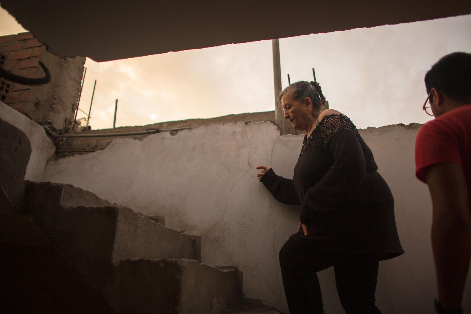 © Daniela Rivera Antara - Going up stairs to the roof top to watch the sunset after Marisol arrived home from work.
