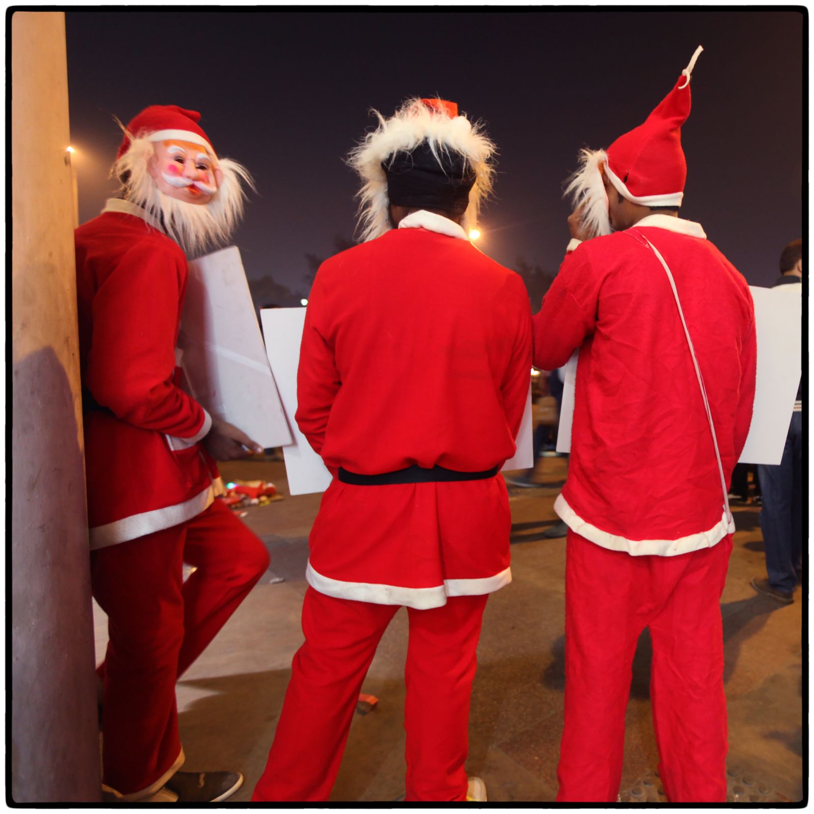 © Vijay S. Jodha - Men dressed as Santa Claus to promote a store selling kids wear.