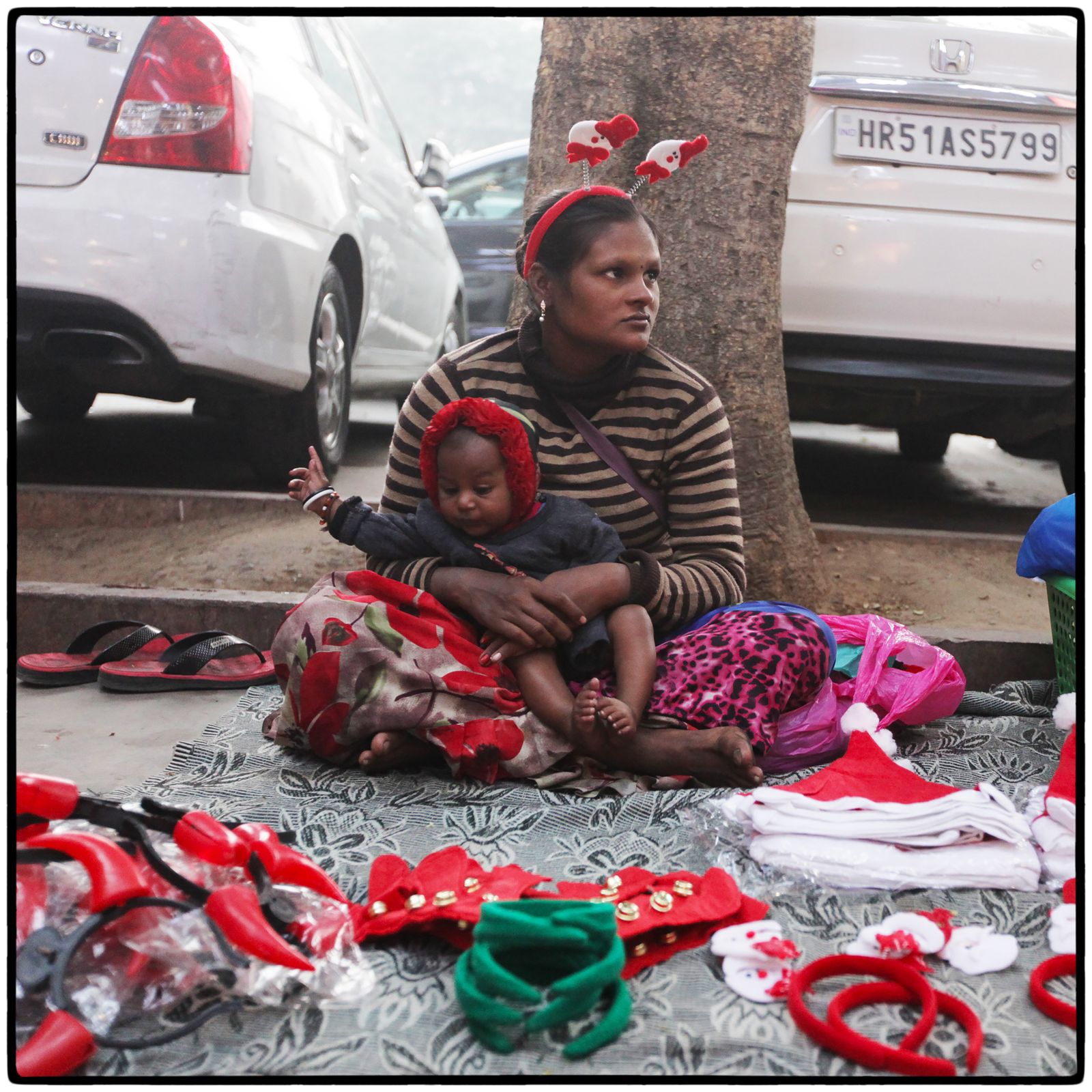 © Vijay S. Jodha - Woman with an infant waits for customers.