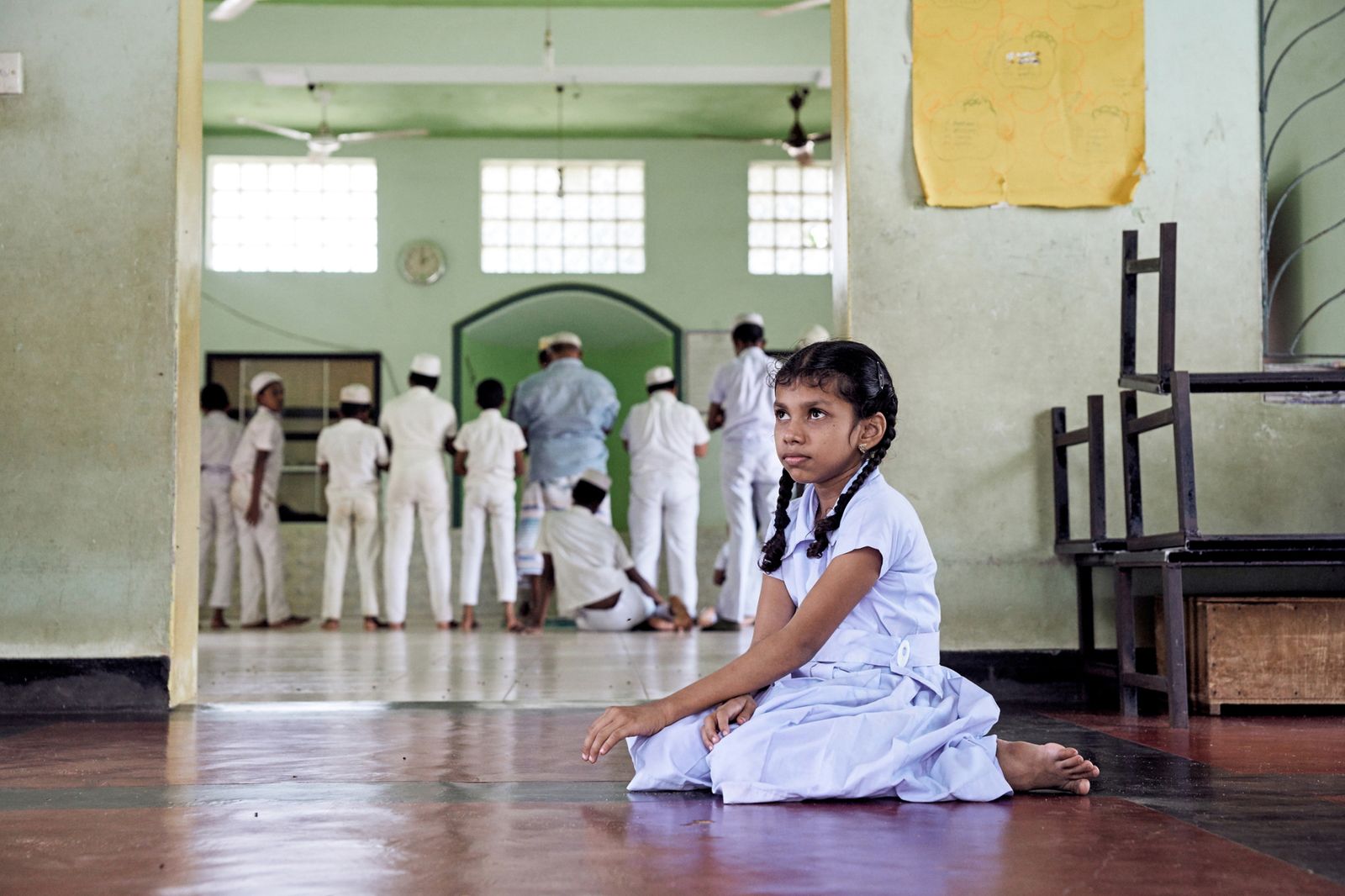 © Kai Yokoyama - Ilma prays at the school's mosque. Deaf, she cannot hear herself or the voices of others during the call to prayer.