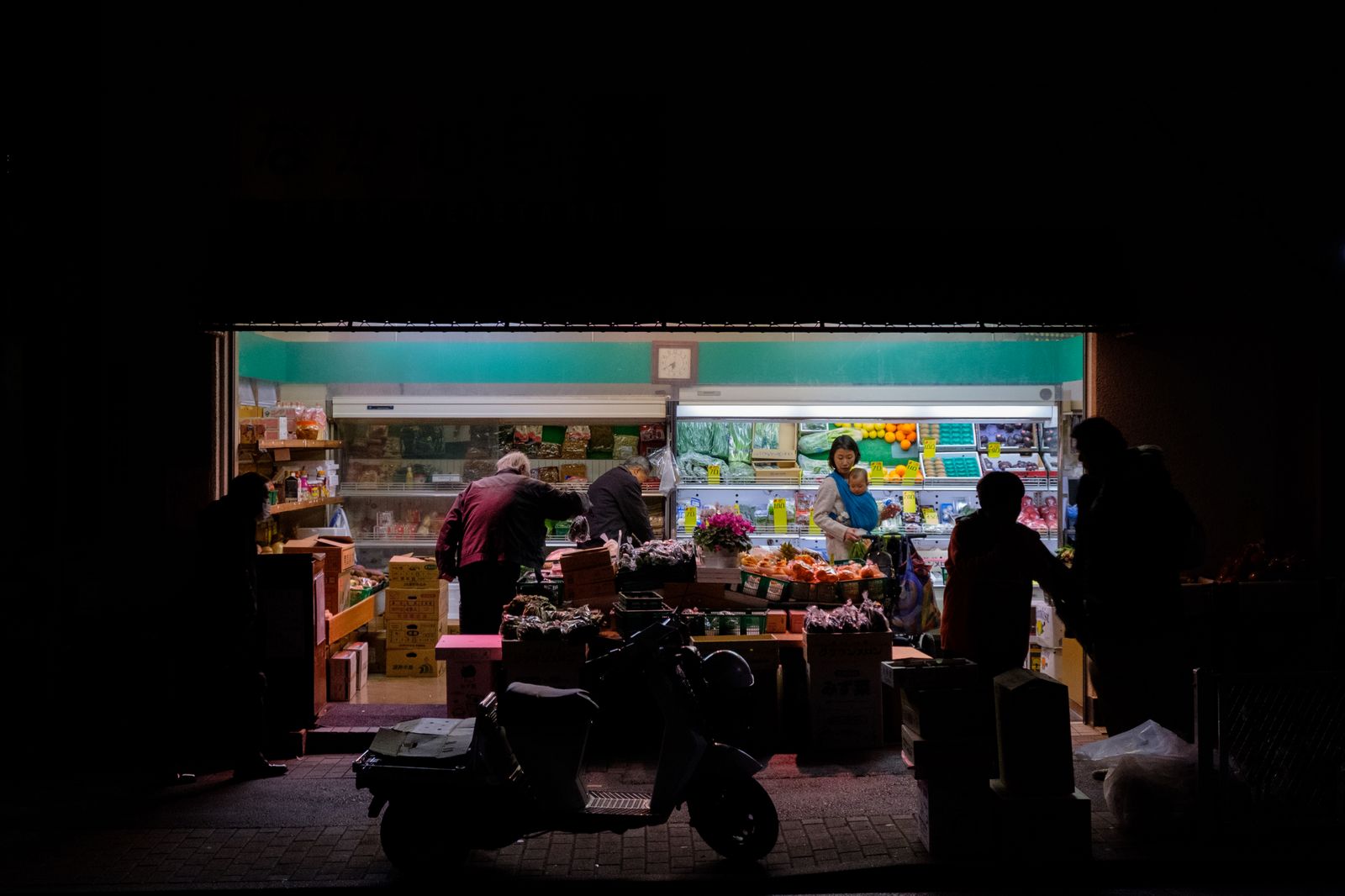 © Vincent Dupont-Blackshaw - Night Seller. Bustling grocery sore lights up the street after dark for locals residents to shop.