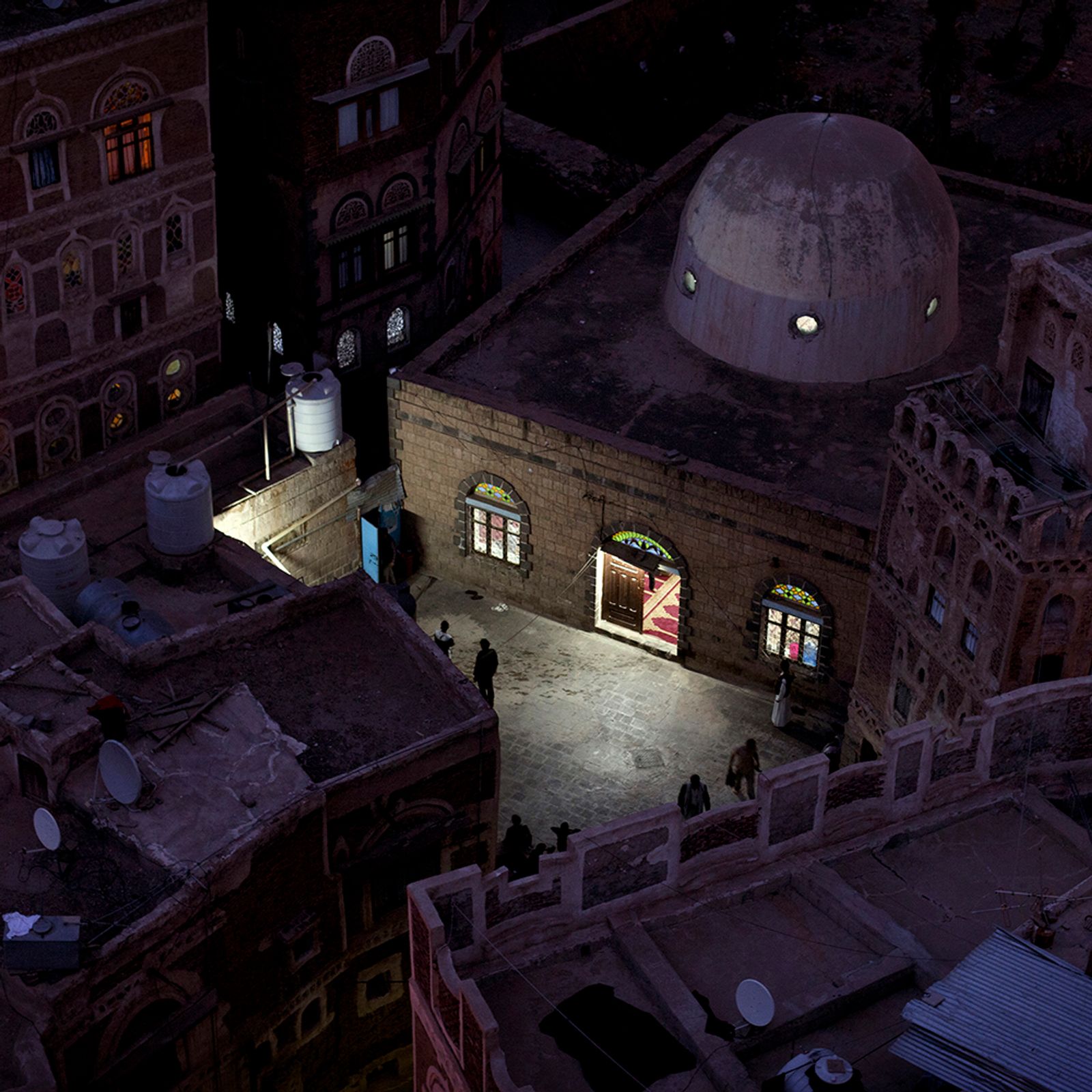 © Loulou d’Aki - View over a mosque at dusk in the Sana’a Old City, Yemen.