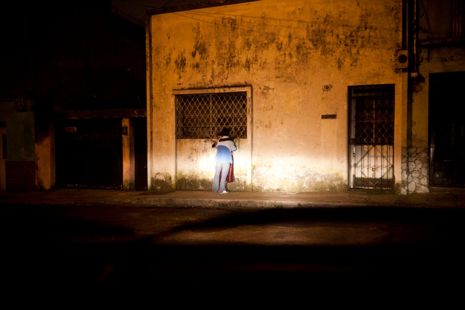 © Lianne Milton - A young couple is found kissing late at night in Zone 1, Guatemala City, Guatemala, on Thursday, Nov. 3, 2011.