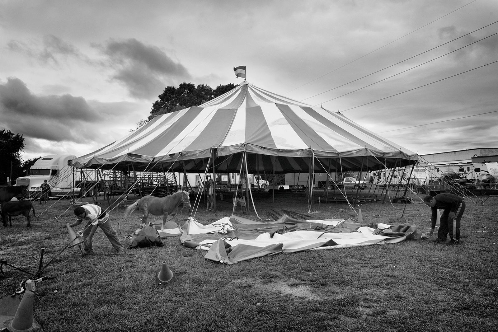 © Lieh Sugai - Workers pack up the tent after the show –the circus moves to the next destination.