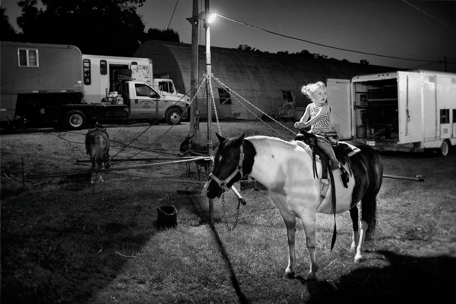 © Lieh Sugai - Child on a pony outside the tent in Brooklyn, Iowa.