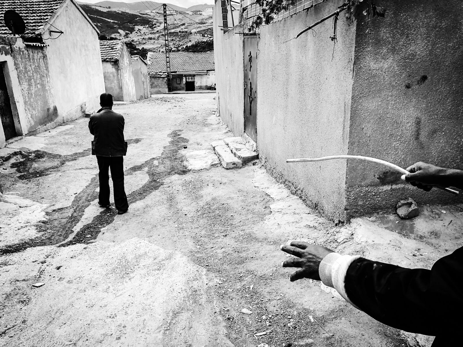 © Fethi Sahraoui - Ali reaching his house while a villager walking with his hunting dog, Kahwet El Rih, Algeria, 2020