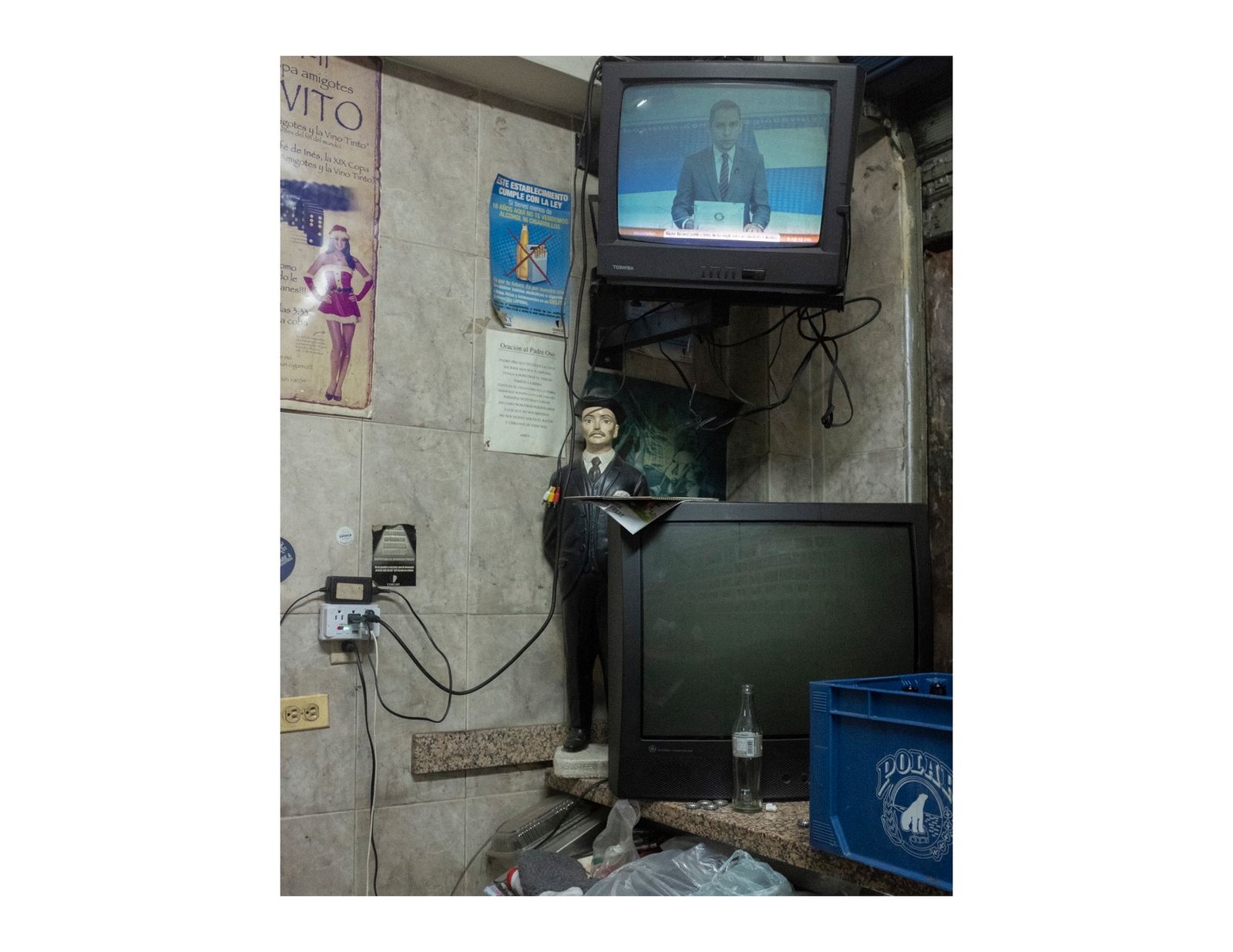 © Andrea Hernández Briceño - A figurine of the beatus Jose Gregorio Hernandez in a bar in Caracas, Venezuela, on August 8, 2018