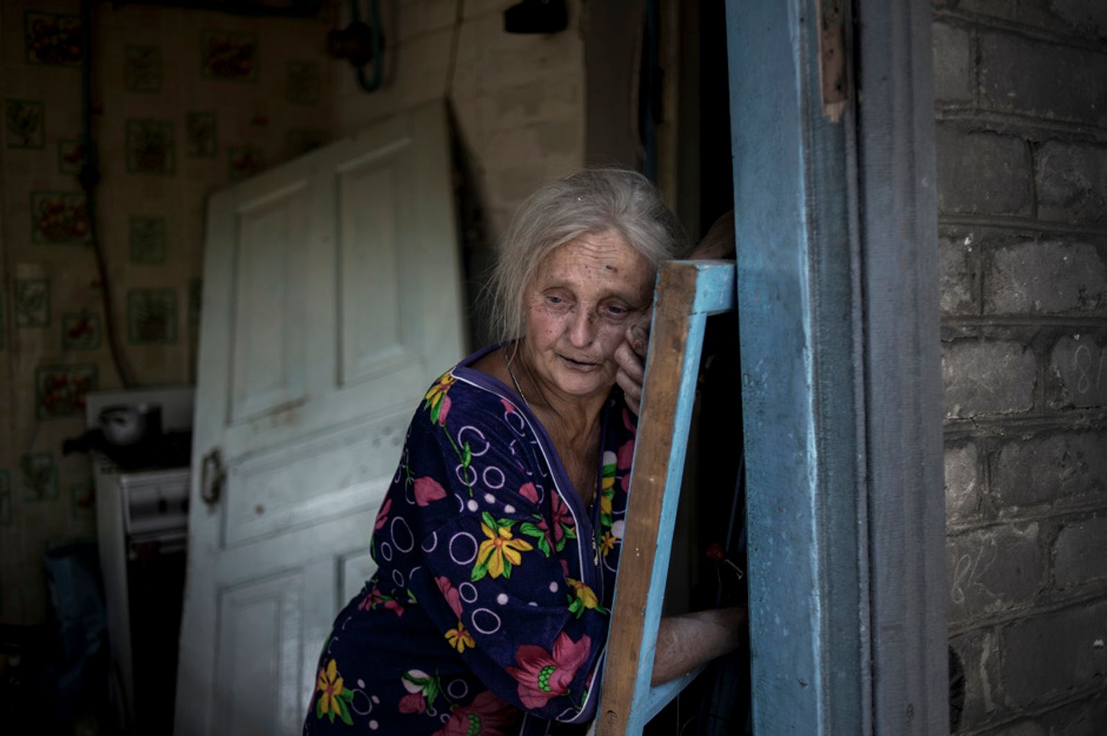 © Valery Melnikov - Local resident Galina Lobach, 67, in the village of Luhanskaya after the air attack