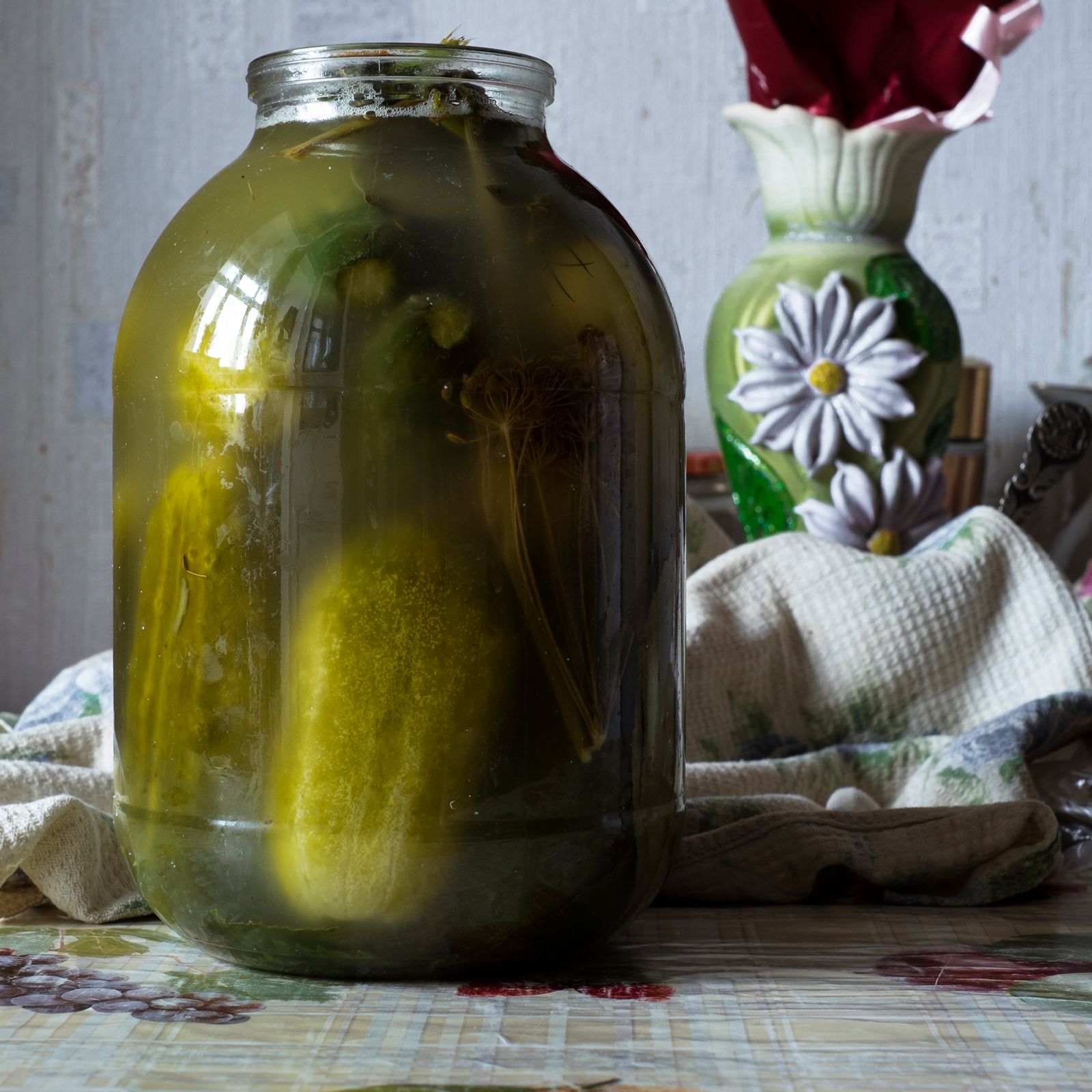 © Maria Quigley - A newly prepared jar of pickled cucumbers stands on the kitchen table.