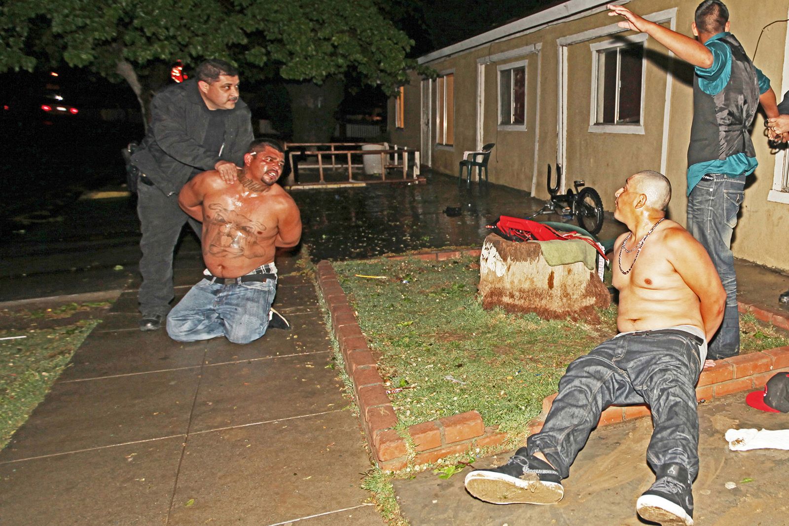 © Richard Street - Officers David Goday and Jose Arsiga wrestle with Bulldog gang members following a riot in the Sonora bar.