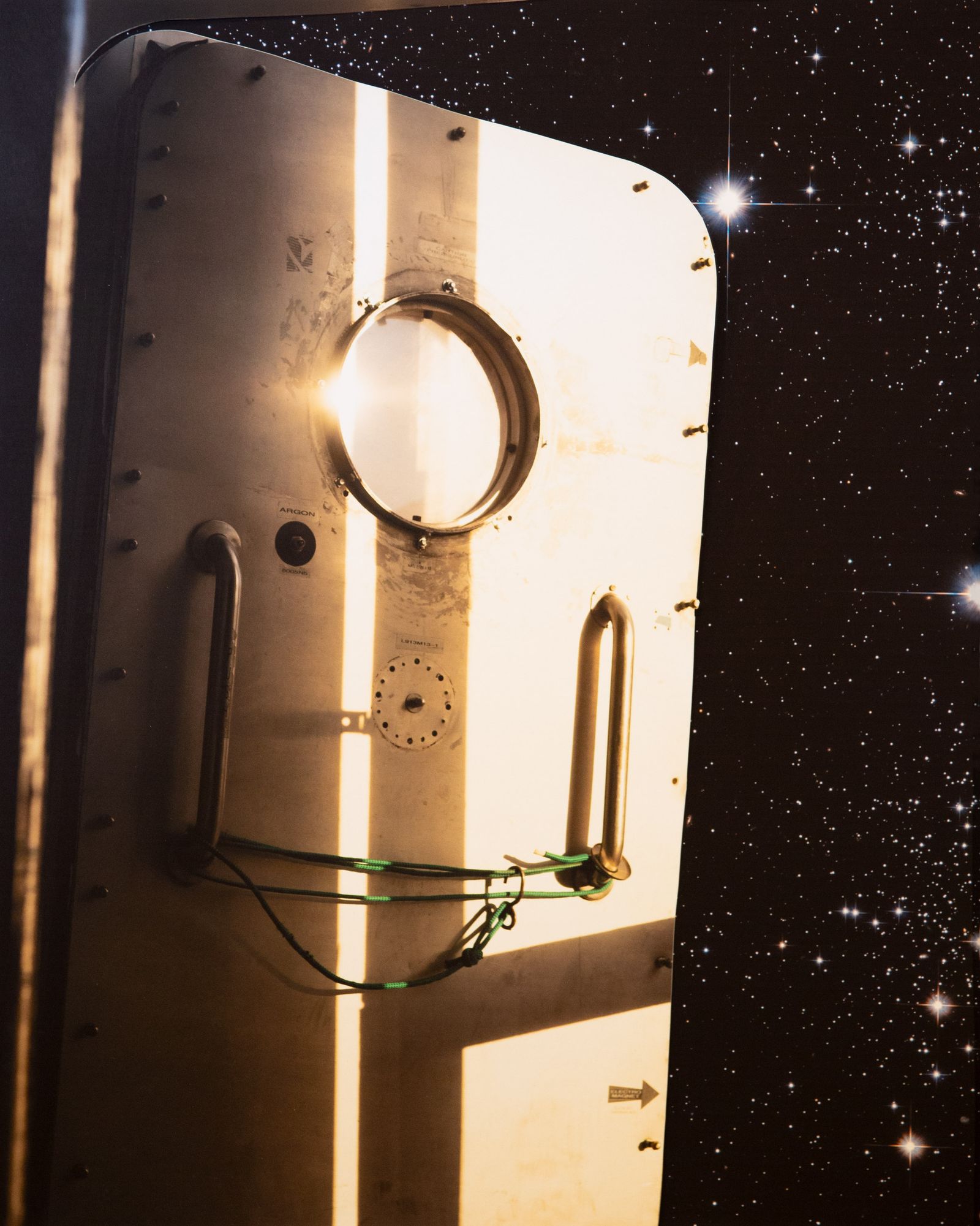 © Kris Davidson - Handmade collage using a Hubble-captured starscape and an image of the airlock door at the Mars Desert Research Station.