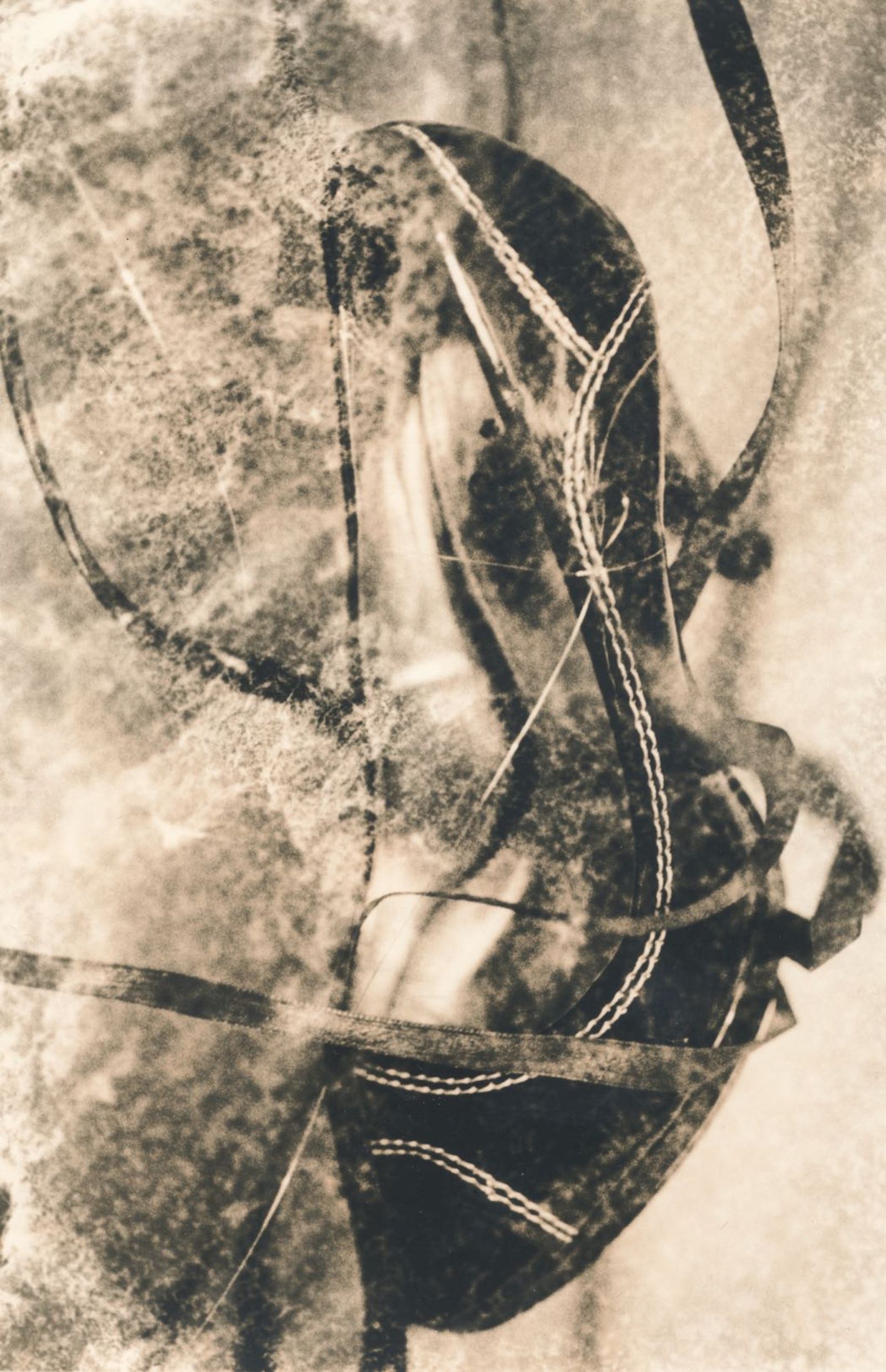 © Jo Stapleton - Flying shoe with ribbons. Shoe suspended with fishing wire. Lith print (negative distressed with tissue paper)