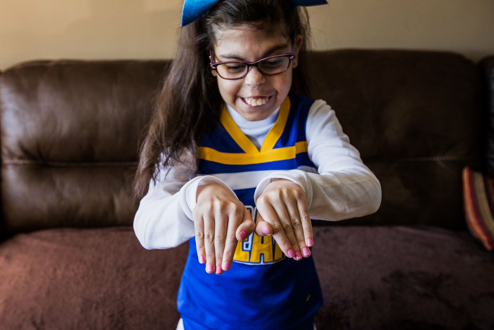 © Karen Haberberg - THOUGH GIANNA HAS HAD 26 SURGERIES, SHE IS STILL ABLE TO PARTICIPATE IN HER TOWN’S GENERAL CHEERING SQUAD.