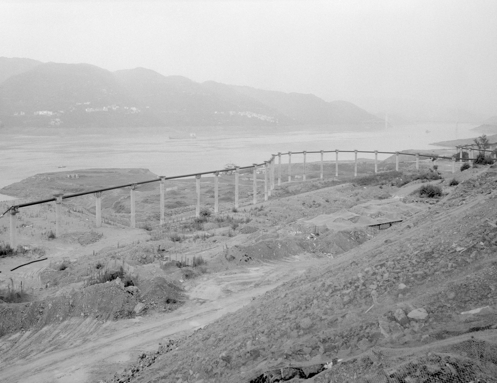 © Yexin Qiu & Moying Zhang - The energy pipeline under construction aside the river.