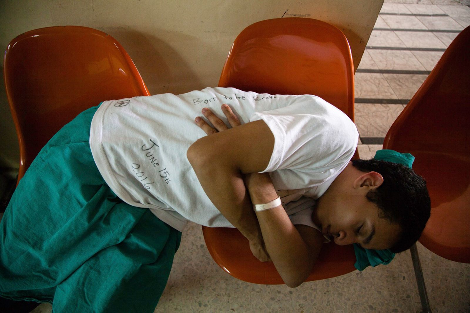 © Anneke Paterson - A young man rests while he awaits his procedure. Central Military Hospital, San Salvador, El Salvador, 2016.