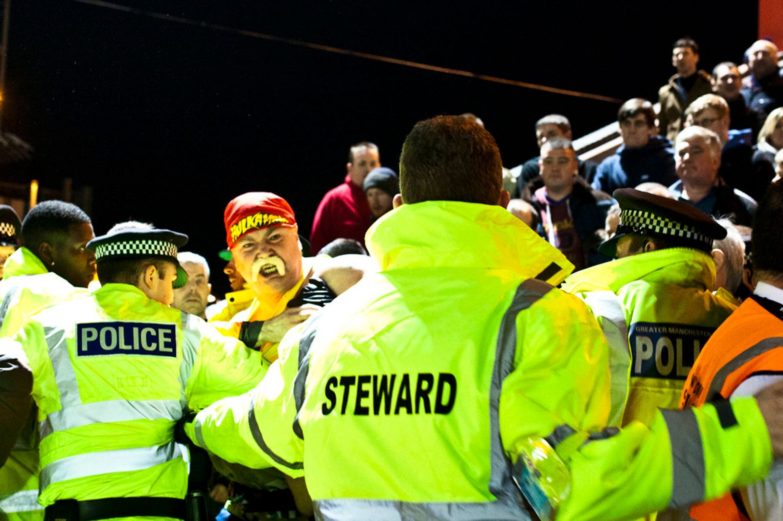 © David Shaw - Hulk Hogan (Tony) is wrestled by Police and stewards at Rochdale away.