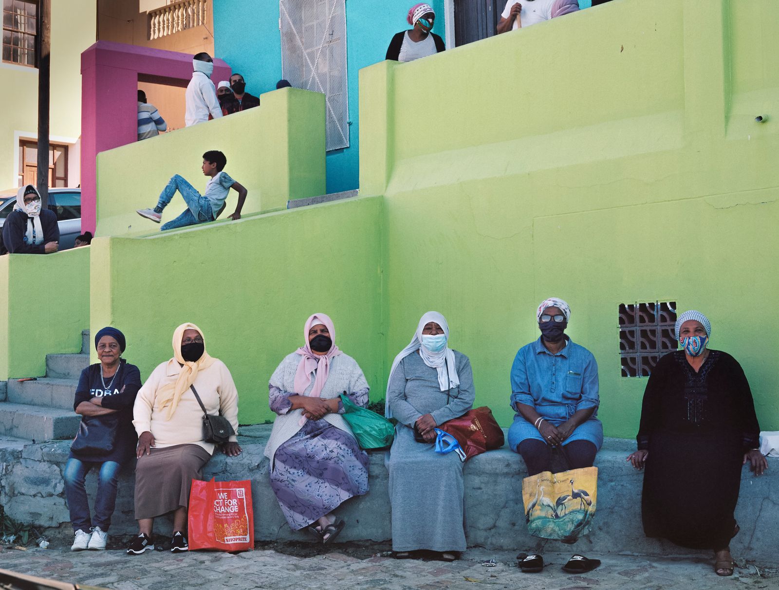 © Ayesha Kazim - A group of women from the community wait for their meals outside of the Bo Kaap Cultural Hub.