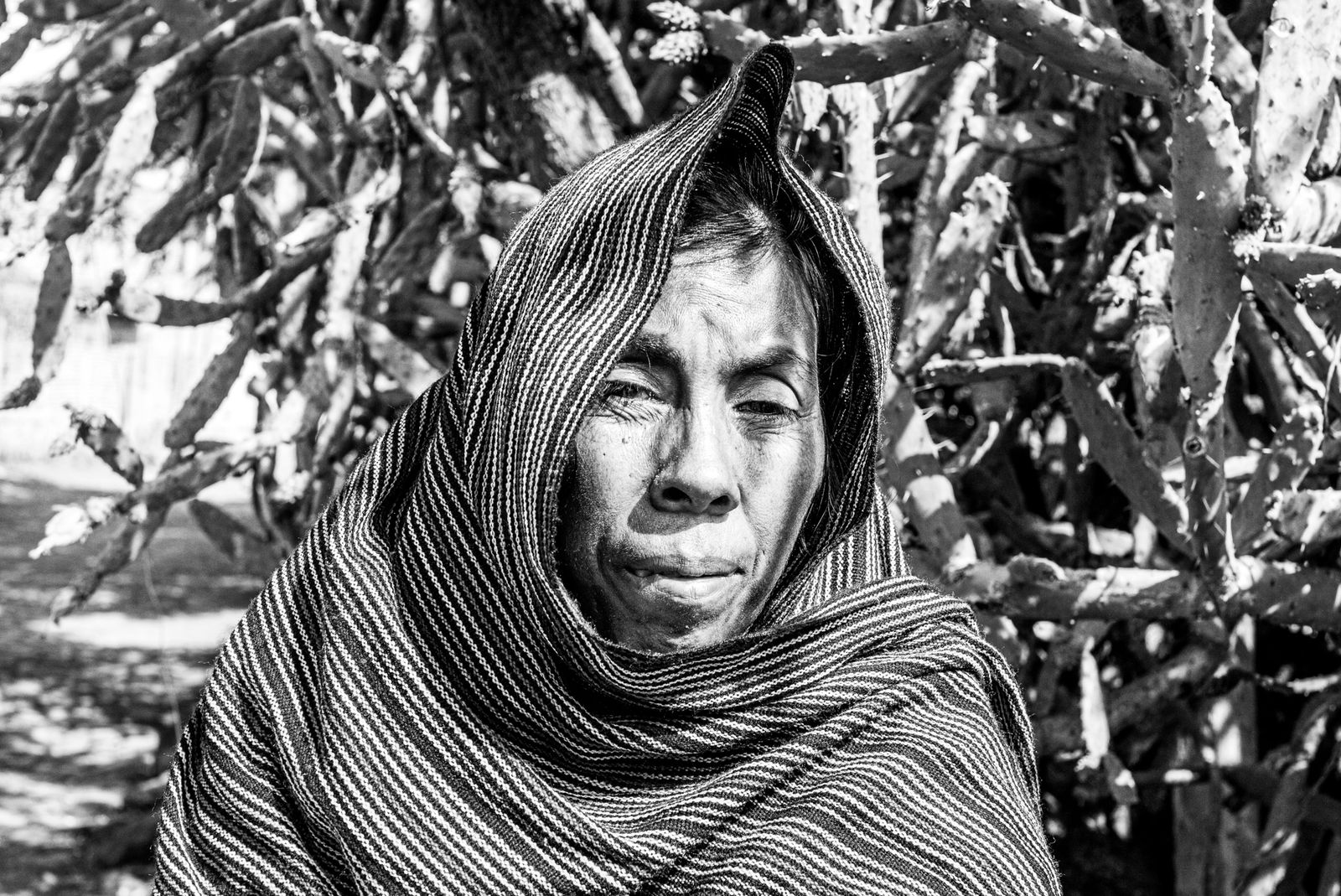© Eduardo Moreno - Flowers around to bring some joy and color to a sad ancestral face