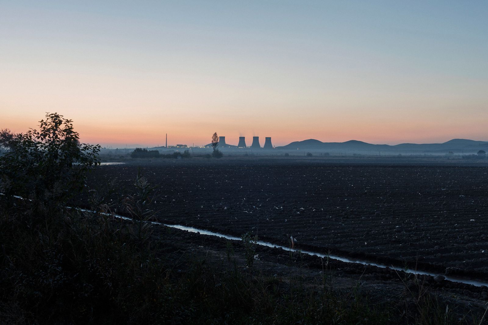 © Stefano Morelli - Arshaluys, Armenia. A view of the Metsamor Nuclear Power Plant from the house of Manvel and Ruzan.