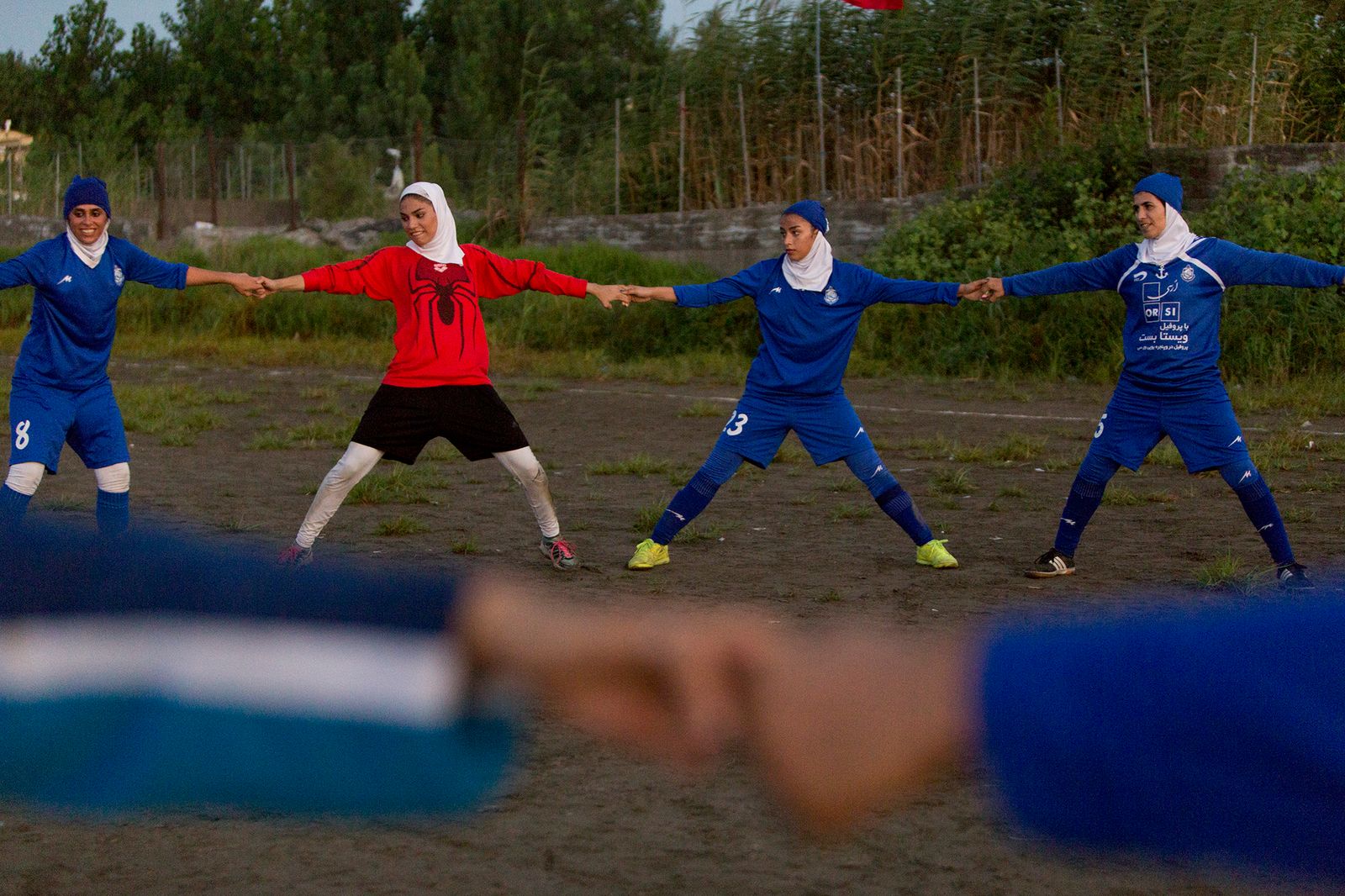 © Azadeh Besharati - The players were warming up to start their football game...
