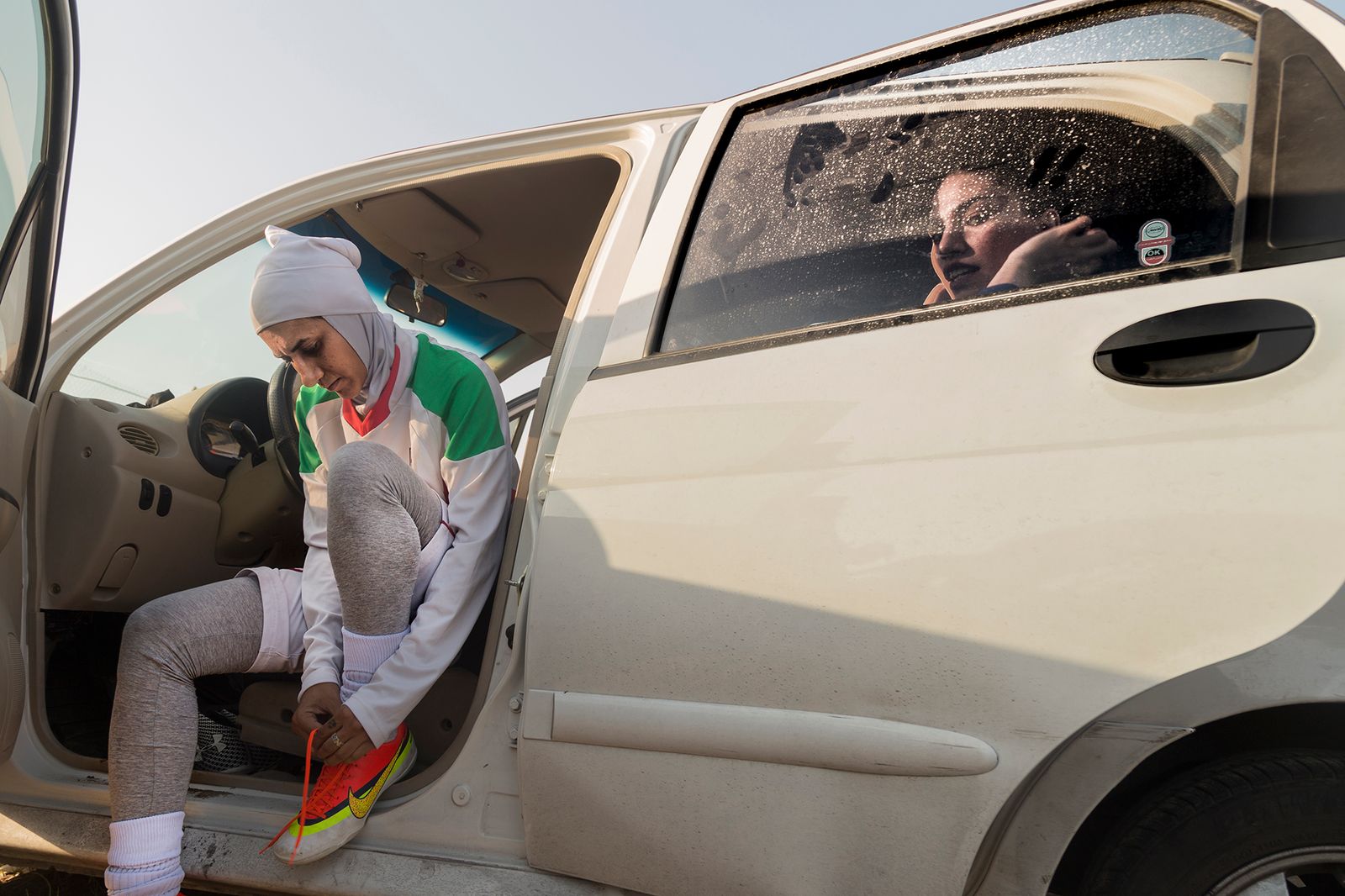 © Azadeh Besharati - The players who were lost their clubs and their football ground, were changing their cloths in their own cars.