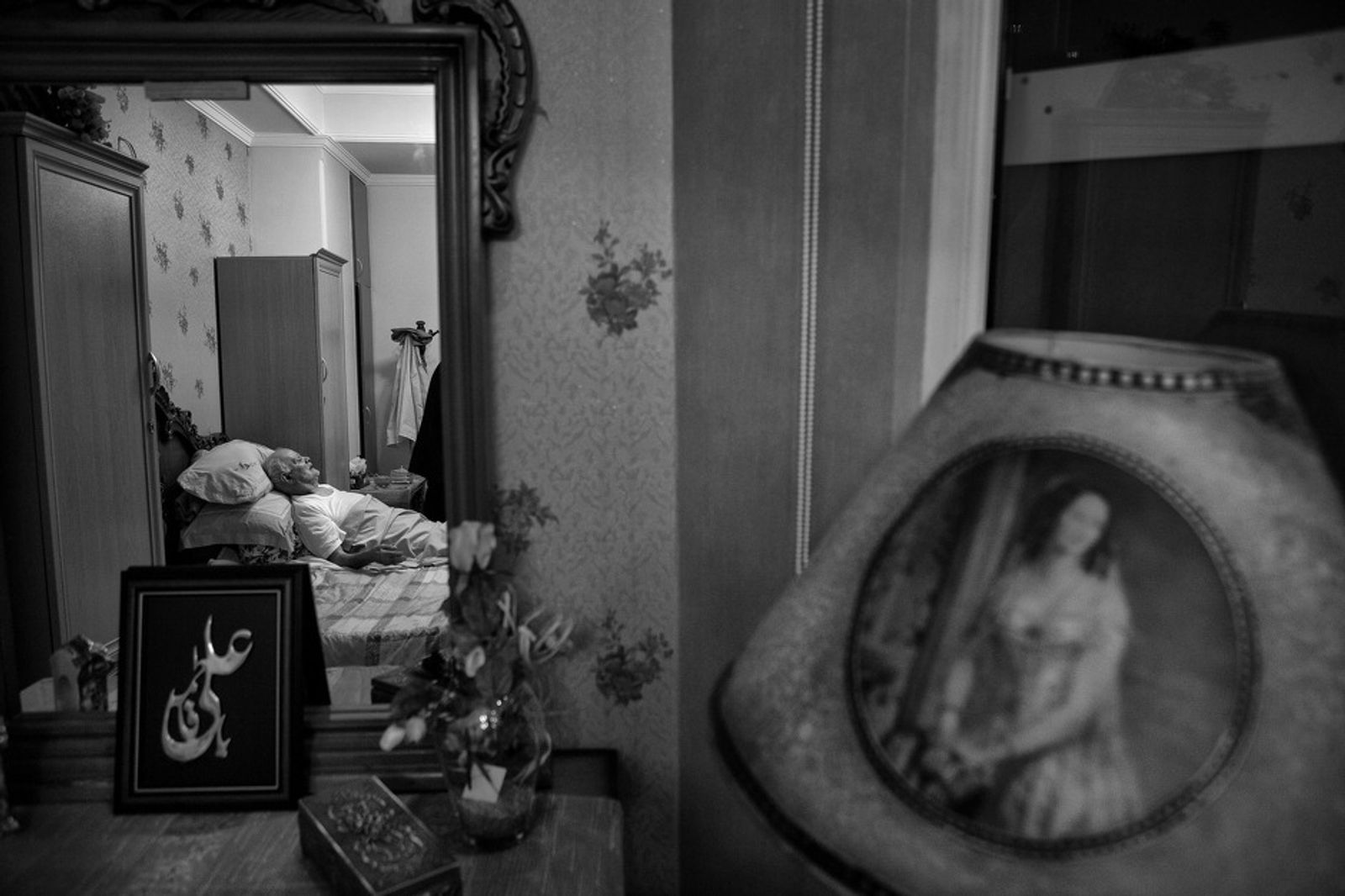 © Jalal Shams Azaran - Father is sleeping in the mirror. There is Imam Ali’s name the Muslims’ Imam in the frame.