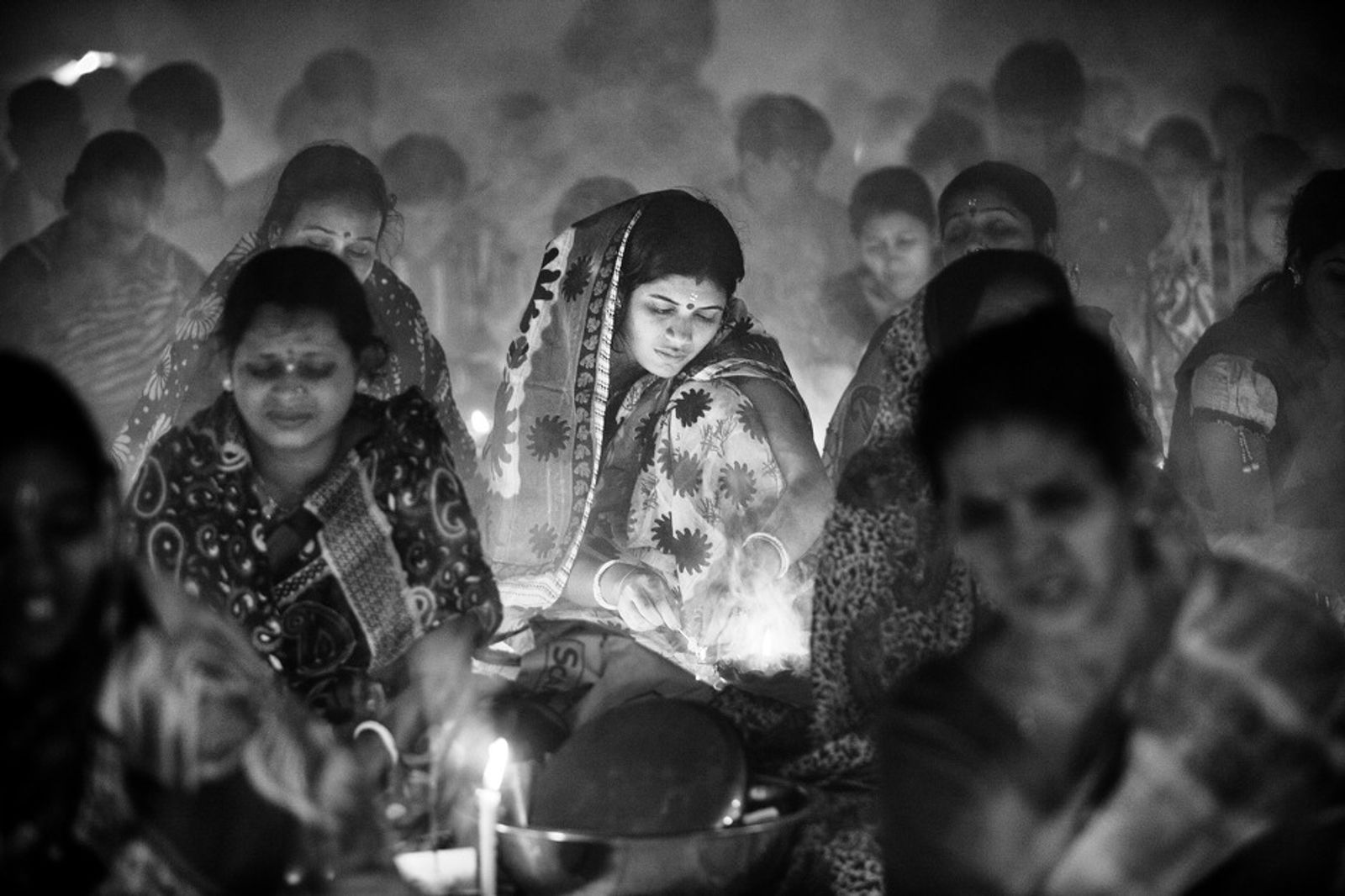 © Suvra Kanti Das - A Hindu woman lit Pradips for special prayer during the Rakher Upobash at Barodi, Near Dhaka, Bangladesh.