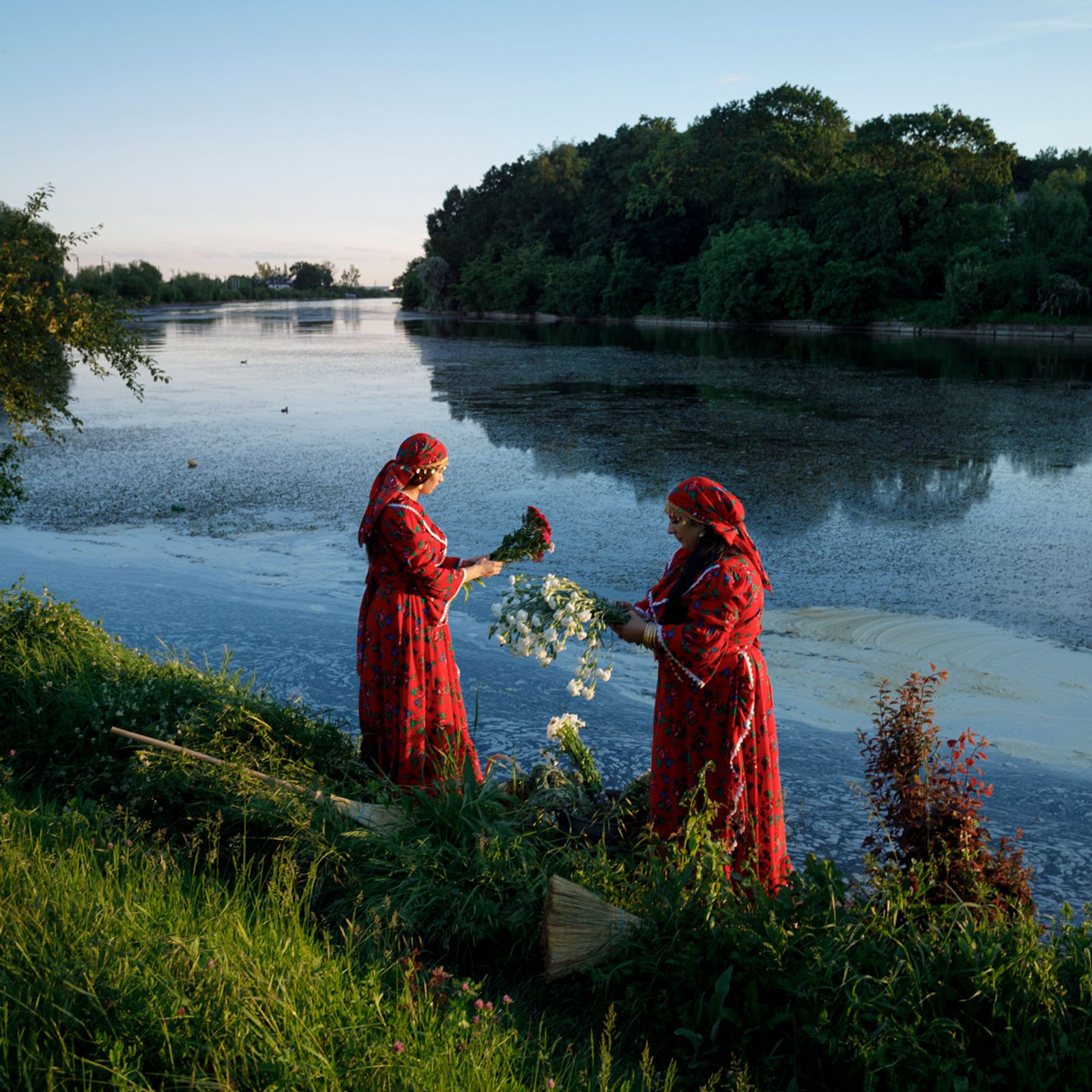 © Johanna Maria Fritz - Larissa and Mihaela stand beside the river Chitila during a ritual. Mogoșoaia, Romania, 2019.