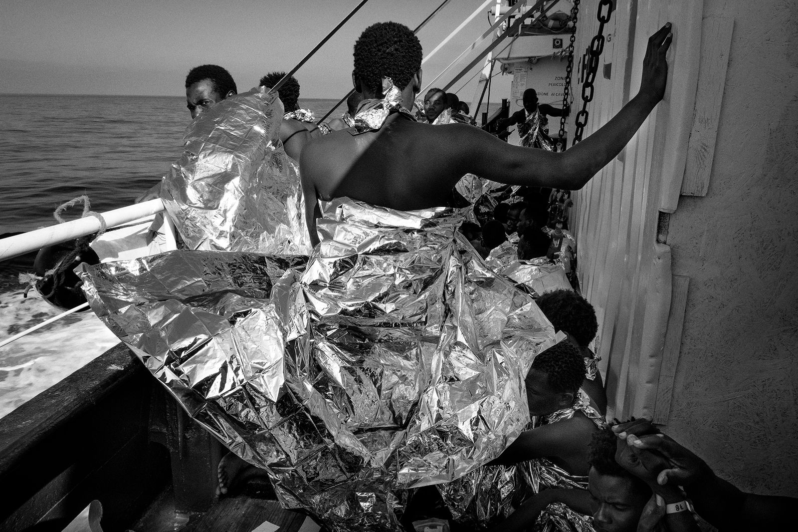 © Francesco Bellina - A migrant, on board the ship "Mare Jonio", wears the thermal blanket, after the rescue.  