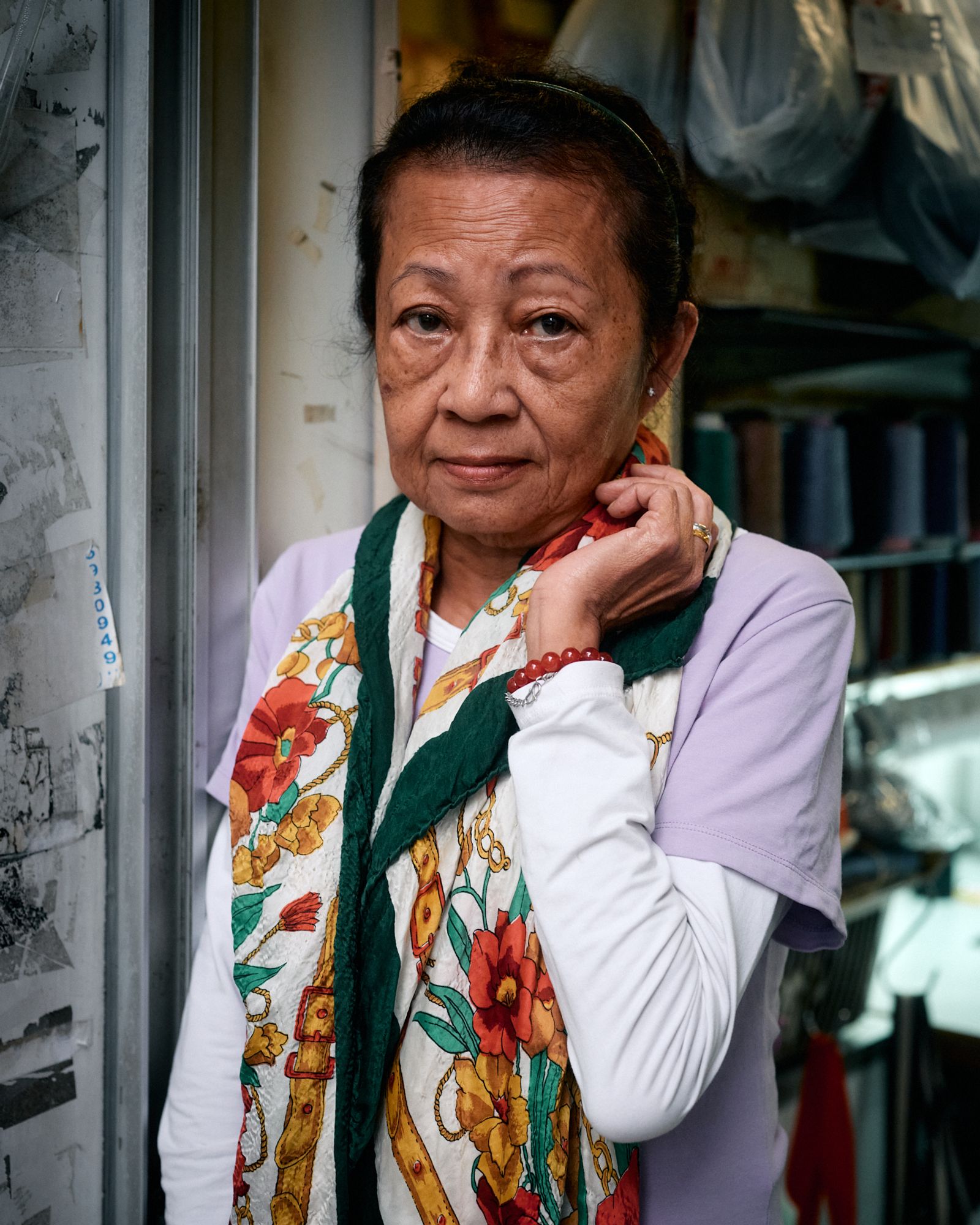 © Chung-wai Wong - Madam Wong, in front of her tailor shop.