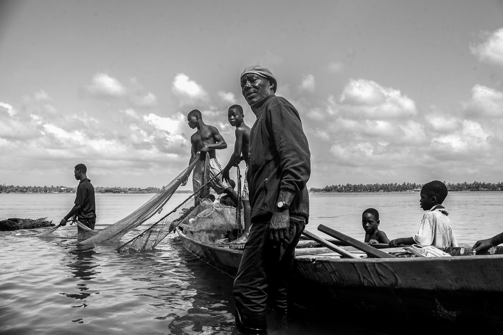 © Ofoe Amegavie - An elderly fisherman helps the younger generation to set up their fishing nets on the shallow banks of the Volta River