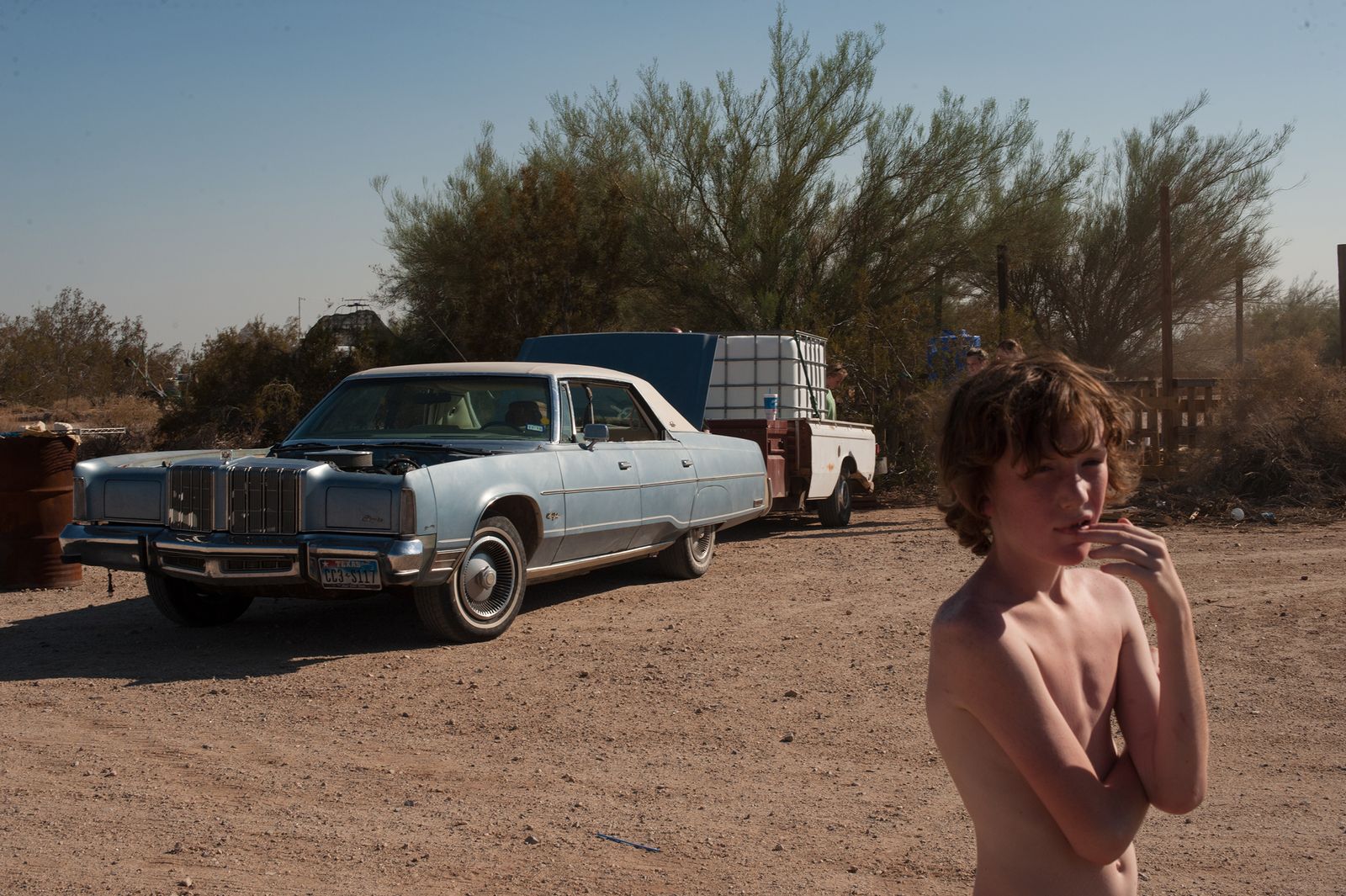 © Jason Houge - Leaf stands by as the first water delivery is made to the new pig pen at the California Ponderosa; Slab City, USA 2018