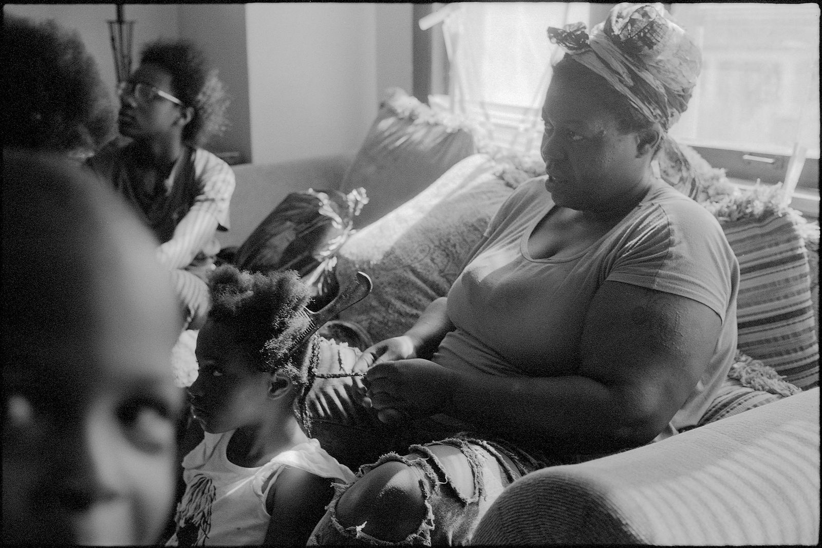 © Jason Houge - Surrounded by family, LaShawnda's Mother, Jacqueline, braids JuJu's hair; Milwaukee Wisconsin