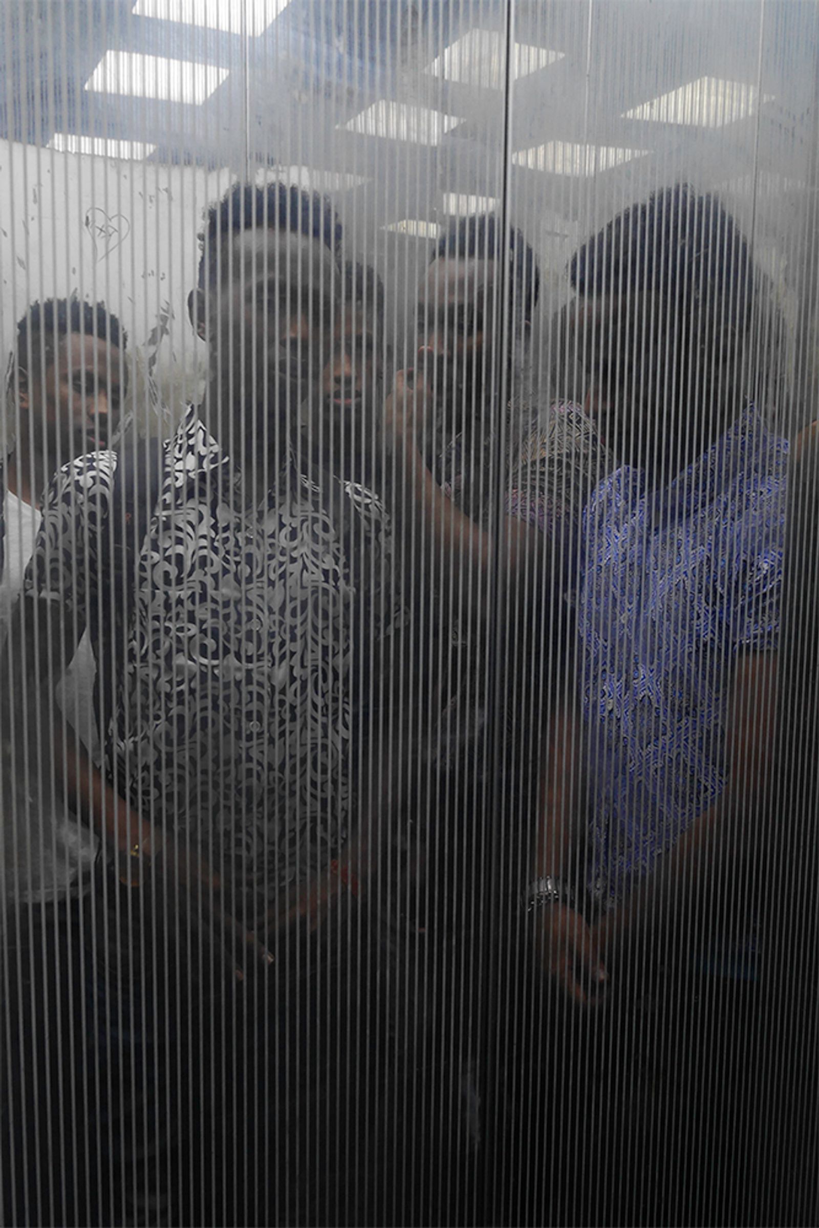 © Min Ma Naing - Somalian youths are seen at the elevator of their apartment, Dhaka, Bangladesh, on 13th April 2018.