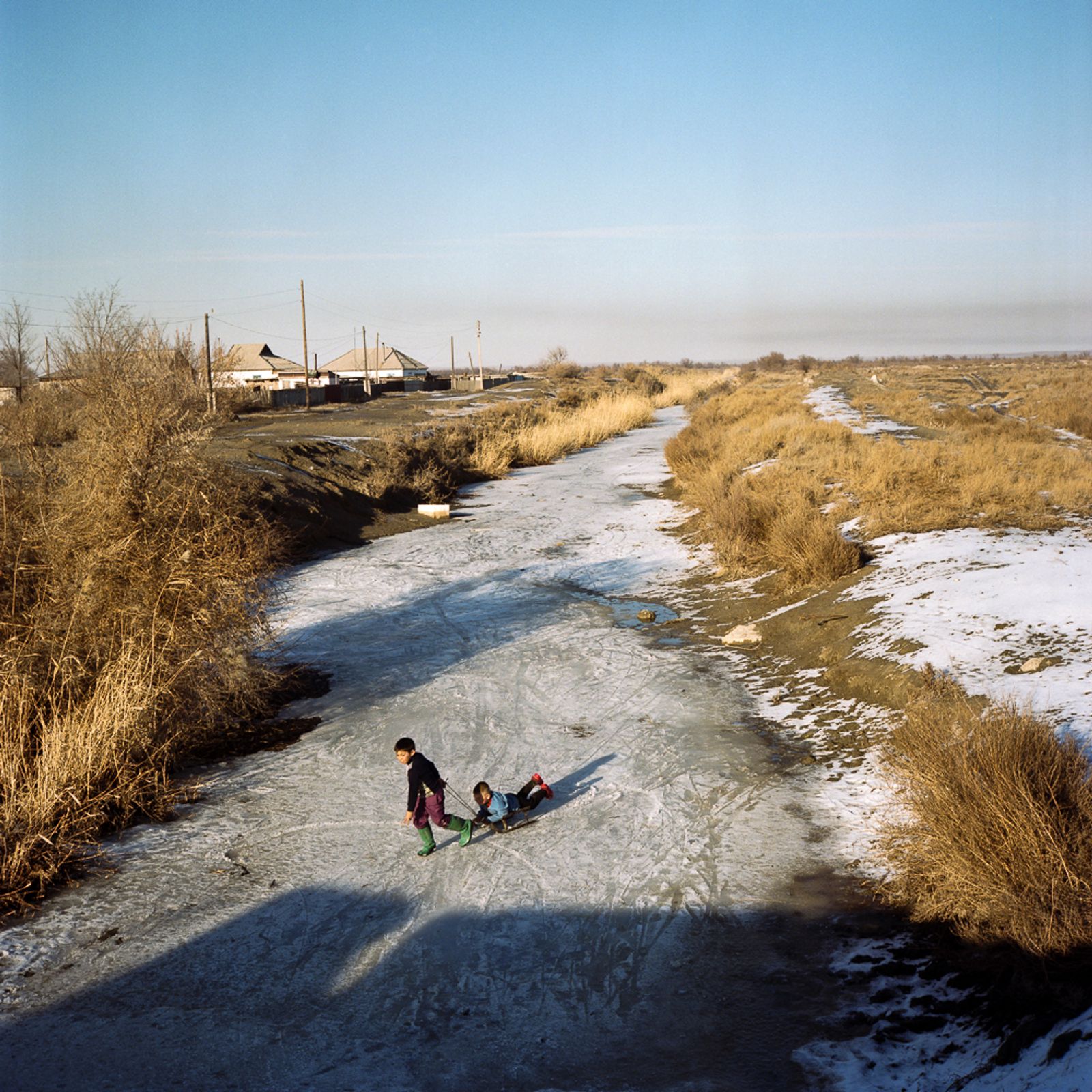 © Michael Vince Kim - Kazakh children playing on a frozen river in Ushtobe, the first place Koreans were deported to in 1937.