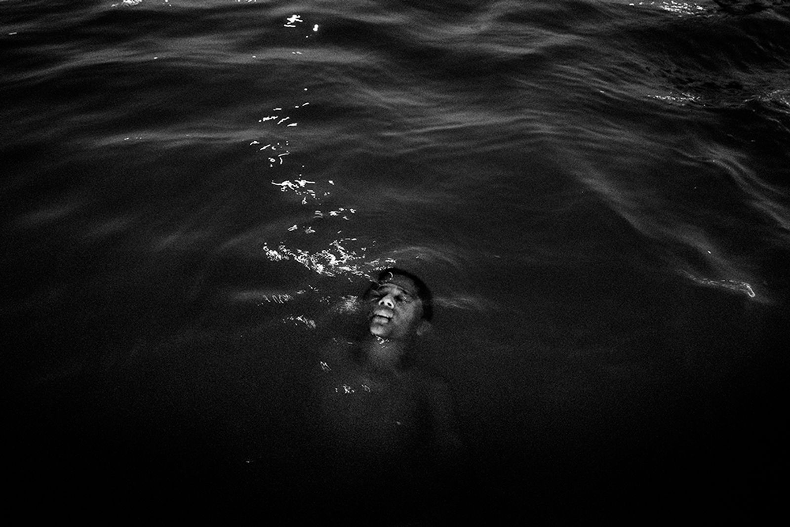 © Tommaso Protti - A boy taking a bath at night in the Tocantins river, a tributary of the Amazon River in the state of Pará.