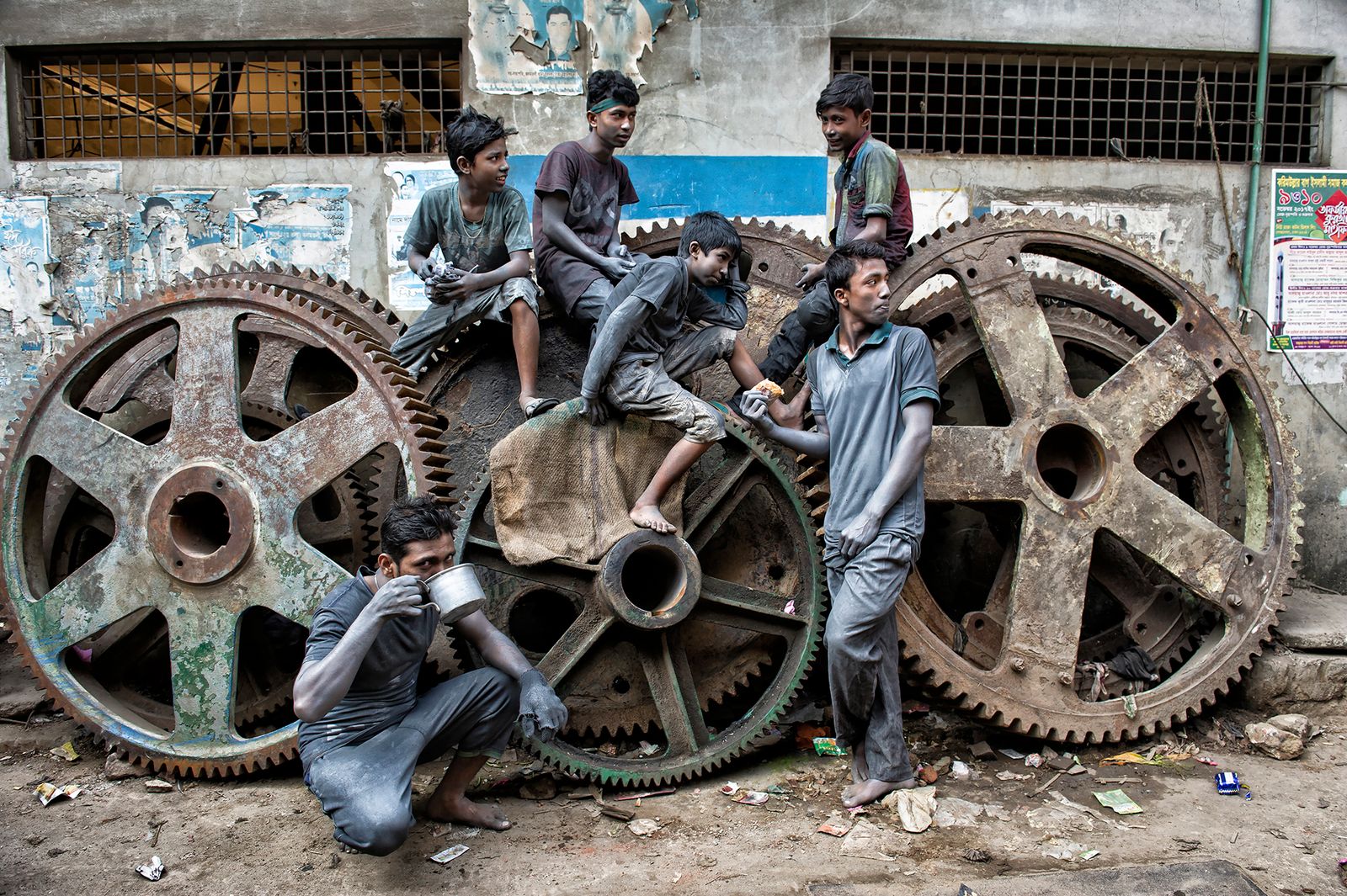 © Valerie Leonard - MODERN TIMES. Lunch break on old tanker wheels in aluminium factories.
