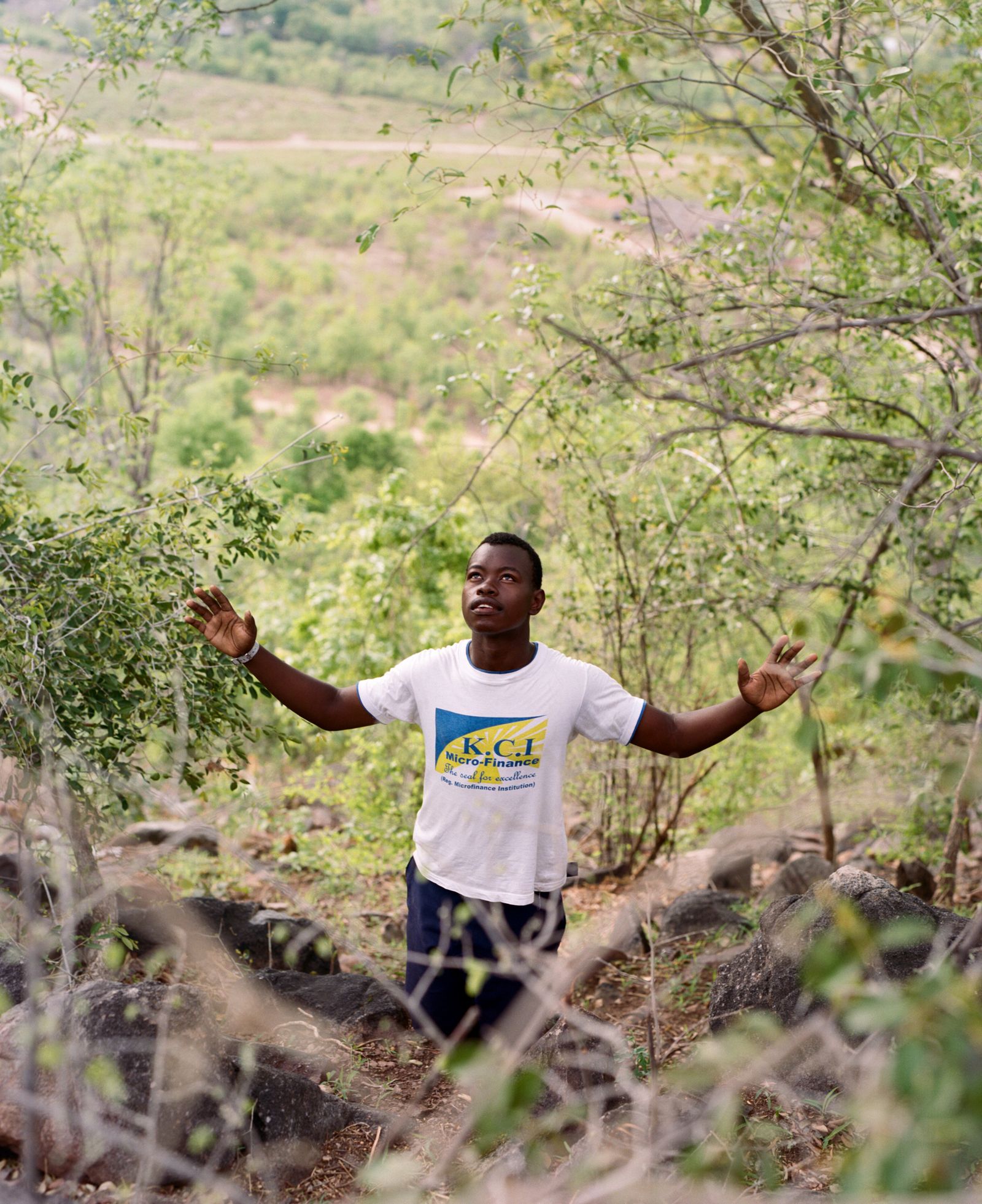© Jono Terry - Timothy Chaparira, praying at a newly deemed sacred location atop a hill overlooking Nyamunga township in Kariba.