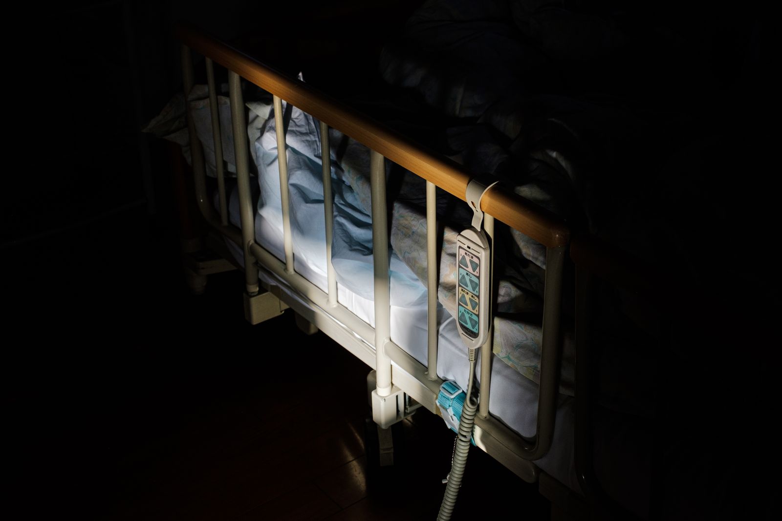 © Yuki Iwamura - The bed frame of the cancer patient is lit by the sunlight on November 20th, 2019 at Aiwa Hospice in Nagano, Japan.
