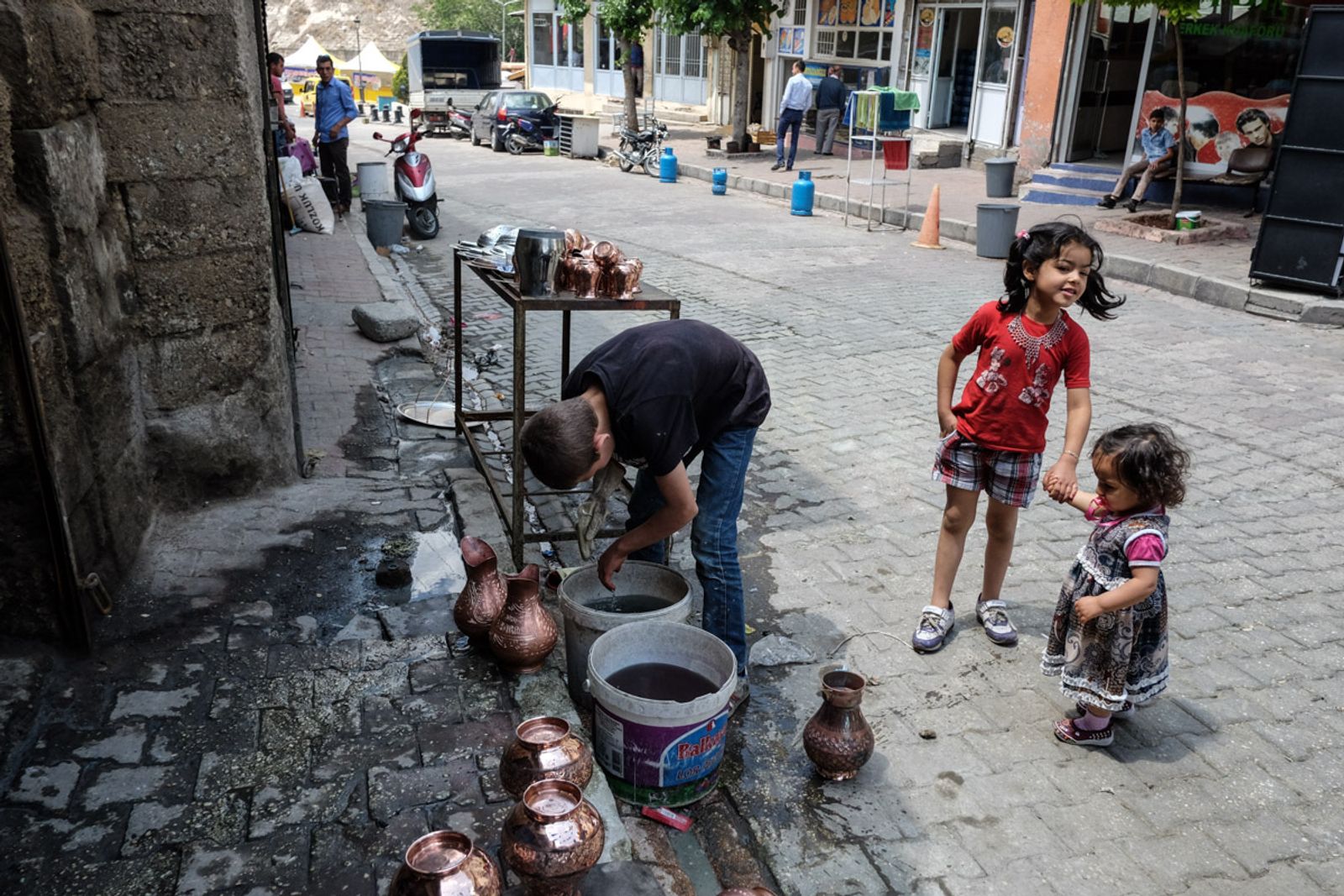 © Valerio Muscella - A kid is seen working while washing pots. Gaziantep, Turkey. May 2016.