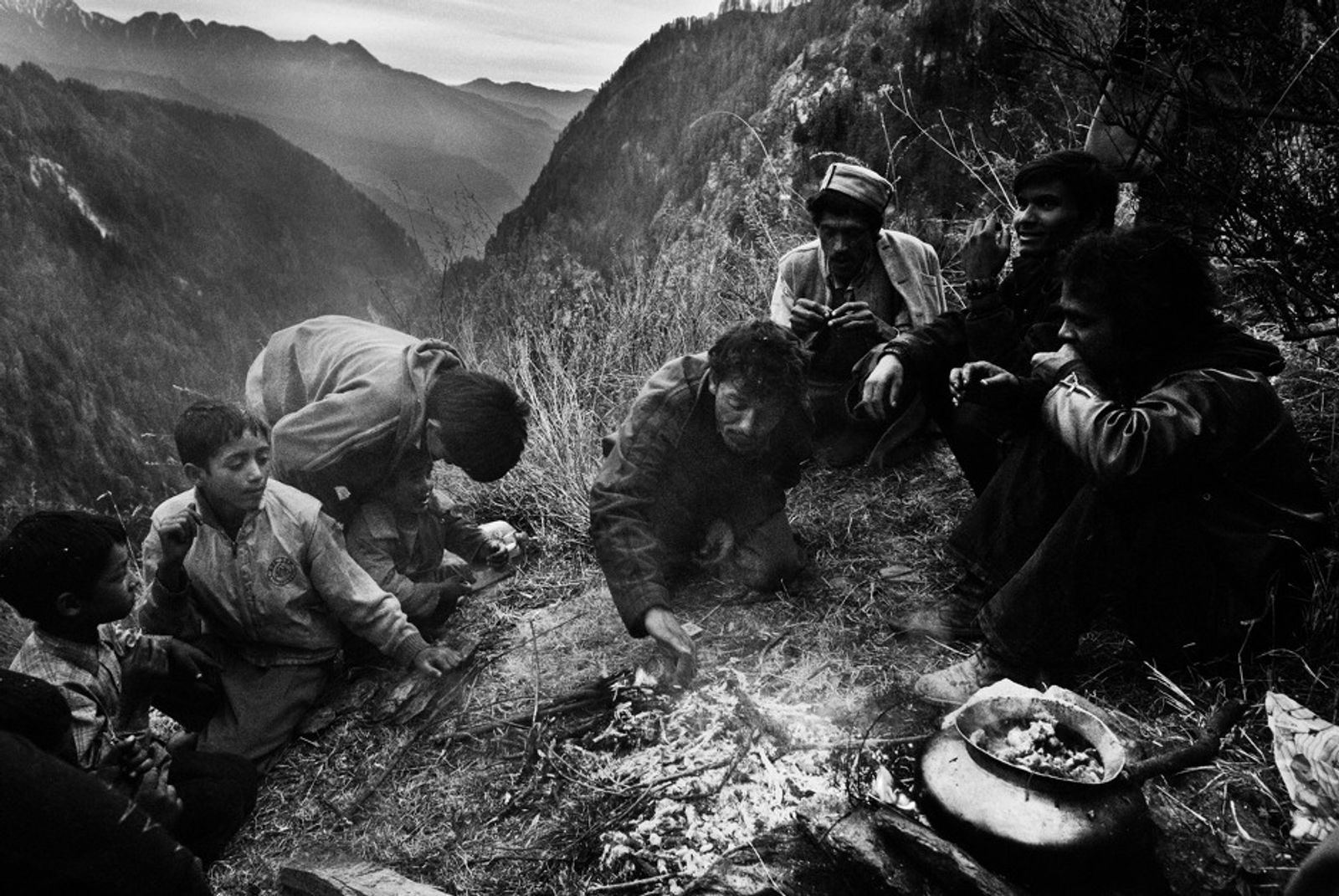 © Harikrishna Katragadda - Boys gather around a fire for an evening meal on a hill side.