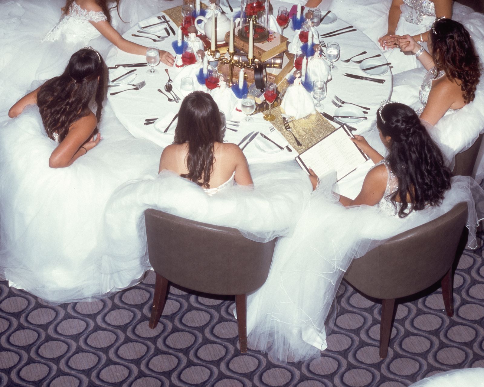© Samantha Cabrera Friend - Group of quinceañeras sit together at main dining hall on board.