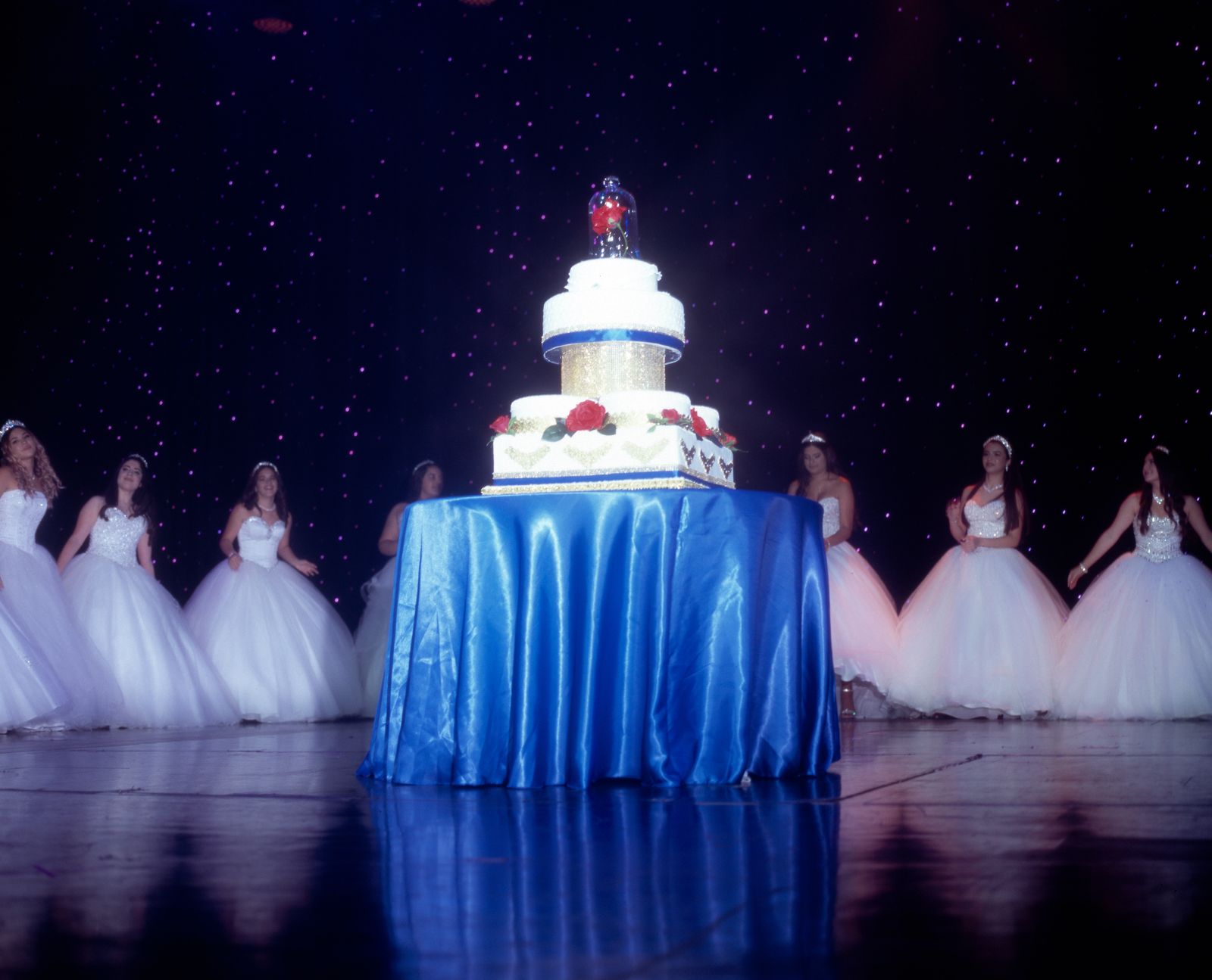 © Samantha Cabrera Friend - A surprise cake for the quinceañeras arrises from beneath the stage.