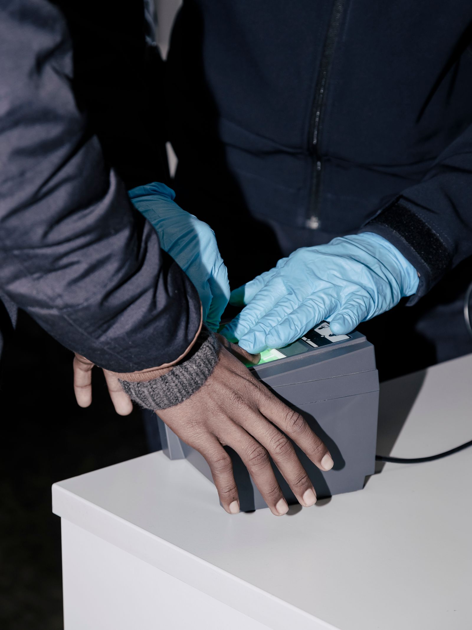 © Salvatore Vitale - Fingerprint registration during an immigration control at the Italian border for an Eritrean asylum seeker.