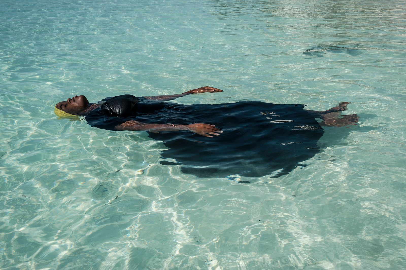 © Anna Boyiazis - A young woman learns to float in the Indian Ocean off of Nungwi, Zanzibar.